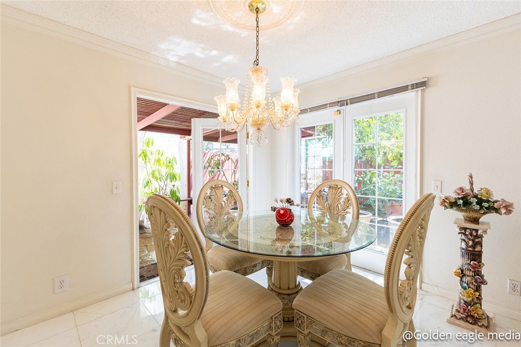 Welcome to 11465 Fox Hollow Ln—a meticulously cared for residence nestled in the desirable California Glen gated with a 24-hour guarded community. This 3-bedroom, 2.5-bath home boasts 1,926 square feet of luxurious living space, offering a refined blend of elegance, comfort, and functionality. You’ll be captivated by its curb appeal and lush trees—all set in a quiet, family-friendly cul-de-sac. Step through the front door and be greeted by sunlight-drenched interiors and Calcutta marble flooring that runs throughout the formal living and dining areas, creating a bright, airy, and opulent atmosphere. The formal living room is adorned with designer mirrors, crown molding, and a white brick fireplace. Just beyond, the dining area showcases a custom Chandelier and two French doors that lead to your private backyard oasis. Back inside, the kitchen is warm and cheerful, featuring white cabinetry, tile countertops, and a large garden window that brings in plenty of natural light. Equipped with a stove, built-in microwave, and ample pantry storage, this kitchen is ideal for the home chef who loves to cook and entertain: a convenient breakfast bar and adjacent dining nook offer casual dining options for busy mornings or intimate evenings. The family room is designed for comfort and entertainment, featuring plush leather seating, built-in cabinetry, and a wet bar with rich, deep mahogany tones and classic, carved detailing on the front panels, showcasing artisan craftsmanship and a vintage appeal. A striking curved staircase with rich wood handrails and classic white balusters, and a grand chandelier that leads upstairs. All three bedrooms, including a master suite with its private bathroom, walk-in closet, and a charming windowbench—the perfect cozy reading spot. The additional two bedrooms are light-filled and spacious, ideal for guests, children, or a home office set up.. Comfort is key here, which is why this home is equipped with central air conditioning and a Nest thermostat, ensuring year-round comfort and convenience, as well as a hidden washer and dryer closet. Wait—this isn’t just a home; it’s a lifestyle. California Glen is one of Pacoima’s hidden gems, offering residents 24-hour guard-gated security, beautifully maintained grounds, and access to a sparkling community swimming pool and spa. Located near major freeways, local parks, shopping centers, and within a short commute to the San Fernando Valley, this home offers convenience without compromise.