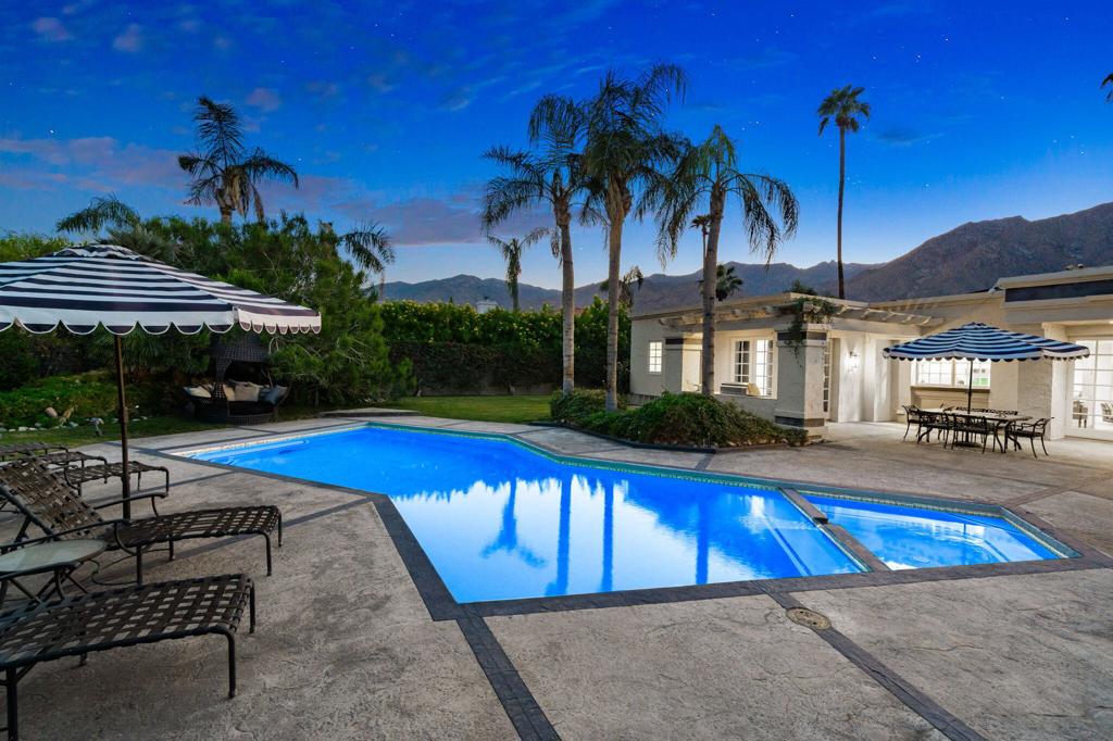 Welcome to Parc Andreas, a private and gated community set above the valley floor in the Andreas Hills. This very private residence is set on a half an acre of land with majestic 360-degree views of the San Jacinto mountains. This home features 14-foot exposed wood beamed ceilings, offering both formal living and dining room areas for large gatherings. All four well-sized bedrooms are ensuite and there are 2 primary suites, one of which offers accessibility, custom built-ins, a gas fireplace, 2 walk-in closets and 2 patios. The floorplan provides privacy for guests with 2 of the bedrooms located away from the primary suite. French doors lead out to the backyard with several entertaining areas, perfect for indoor/outdoor living. The backyard features a salt-water pool and spa with spectacular views and is full with trees and foliage that offers privacy as well as several large grassy areas for pets, lawn games or just pure relaxation. There is a 3-car climate-controlled garage with plenty of storage and 41 owned solar panels. Just minutes away from downtown Palm Springs, Andreas Parc is the ideal location for outdoor activities like hiking, biking and world-class golf. Please call to schedule your private showing of this magnificent home today!