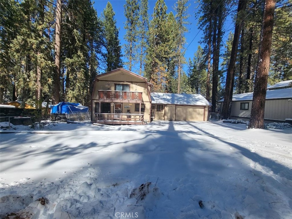 Prime Location!!! Moonridge area within minutes from Ski resorts, restaurants, Alpine Zoo, golf course and much more. This beautiful home is located in a quite and relaxing neighborhood. Walk-in to this cozy spacious home, offering 2 large bedrooms with 2 1/2 bathrooms, including a family room on the second floor. Separate large laundry room. Large driveway to store your RV or boat. Recently finished garage, updated bathrooms and kitchen countertops, and updated lighting throughout the home. Plenty of room to entertain family and friends inside and outside of the home. Smell the pines and enjoy the view as you BBQ and relax. Gather near the beautiful fireplace to keep you warm on those cold Big Bear nights. Don't miss out on this ONE!! Opportunity for investment.