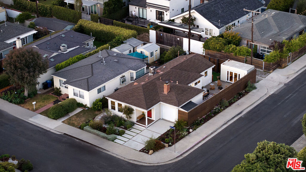 Located in Venice's highly sought-after Silver Triangle, 2432 Cloy Ave is a beautiful 2-bedroom, 2-bathroom bungalow that blends laid-back coastal living with modern style. The open-concept living room features neutral textures and effortless flow into the updated kitchen, which includes stainless steel appliances and high-end finishes. Large glass doors off the kitchen open to a private backyard oasis ideal for entertaining. The outdoor space is fully equipped with a built-in BBQ, beverage tap, fridge, and dining area, all surrounded by modern wood fencing and greenery. A detached studio with French doors offers flexible use as a home office, gym, or creative space. The primary suite includes French doors to a private patio and a spa-like en-suite bath with sleek, modern finishes. A second bedroom and another beautifully updated full bathroom complete the home.Perfectly positioned just minutes from the Venice Canals, Abbot Kinney, Erewhon, and the beach, this home offers the ideal blend of style, comfort, and Venice charm.