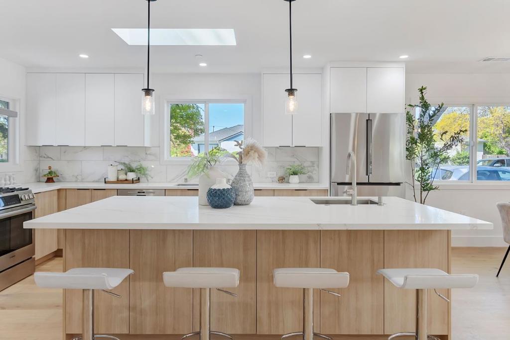 Welcome to this fully renovated and expanded modern residence in the heart of San Mateo. New FOUR bedroom suites and brand-new 476 sqft two-car garage, this stunning home offers a seamless blend of urban style and family comfort. Wide-plank light wood floors, flooded with natural light from multiple skylights and expansive sliding glass doors that lead to an open-concept living and dining area. The chef's kitchen is outfitted with all-new premium stainless steel appliances, an oversized center island, contemporary Euro-style cabinetry, and luxurious quartz countertops accented by marble backsplash perfect for those who love to cook, entertain, and live in style. The primary bath is a true retreat with striking black-and-white tile work, a walk-in rainfall shower, a freestanding soaking tub & designer vanity. Step outside through French sliding doors to a beautifully paved front yard enclosed by a modern white picket fence. The brand-new built garage and extra-wide driveway provide convenience and curb appeal. New roof, new stucco, new drywalls/insulations, new plumbing and electrical, new appliances, new additional bedrooms, and newly built 2-car garage. Quick access to highways, shopping, dining! Top rated school!