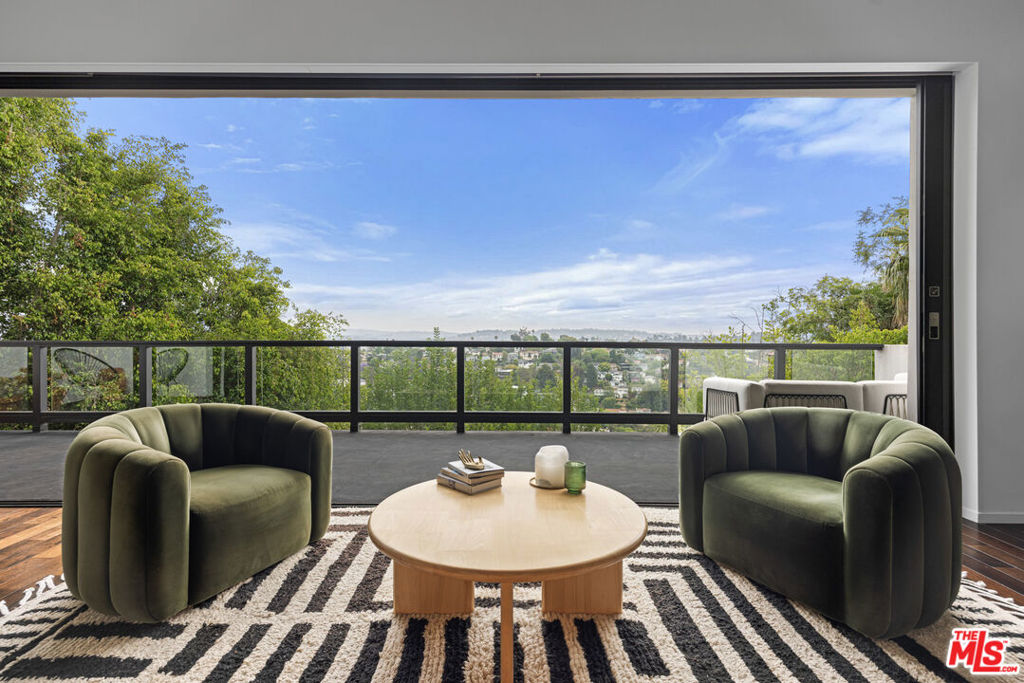 Stunning Contemporary Home with gorgeous city views located in Franklin Hills in the heart of Los Feliz. This 3 bedroom, 4 bath house is turn-key, fully furnished and ready for immediate move-in. Impeccable architectural and interior design with a bright open floor plan, high ceilings and walls of glass doors that open to incredible outdoor spaces with panoramic views. The custom gourmet kitchen has top of the line Viking and Sub-Zero appliances with separate wine storage. Primary suite includes a fireplace, walk-in closet, private patio, spa-like bath, steam shower. The outdoor living area is spectacular. There's a built-in fire pit, multiple seating/dining spaces, full outdoor kitchen, sauna, shower, cold plunge and detached office. This truly has the feeling of a boutique hotel set among the hills with city and mountain views. Other features include smart home automation, camera system, whole-house audio, media room with oversized theater screen, home gym, EV charger, solar panels, 2-car attached garage. Available for immediate move-in.