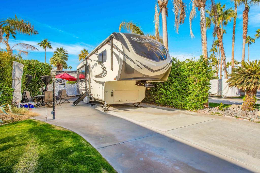 This beautifully maintained interior lot is ideally located near El Saguaro Clubhouse and Satellite D, offering both convenience and serenity. Mature hedging on the patio side and rear enhances privacy, creating a peaceful outdoor retreat. Patio furniture and umbrellas included! This is LOT ONLY Outdoor Resorts Palm Springs is a Five Star RV Resort Community combining luxury with affordability. It is a guard gated resort that sits on 137 beautifully landscaped acres with 27 holes of executive golf, 10 tennis courts, 13 pickleball courts, 8 swimming pools, a fully equipped fitness center, espresso bar, sports bar, beauty salon/barber shop, full-service restaurant, convenience store, 2 club houses, activities, special events and so much more.