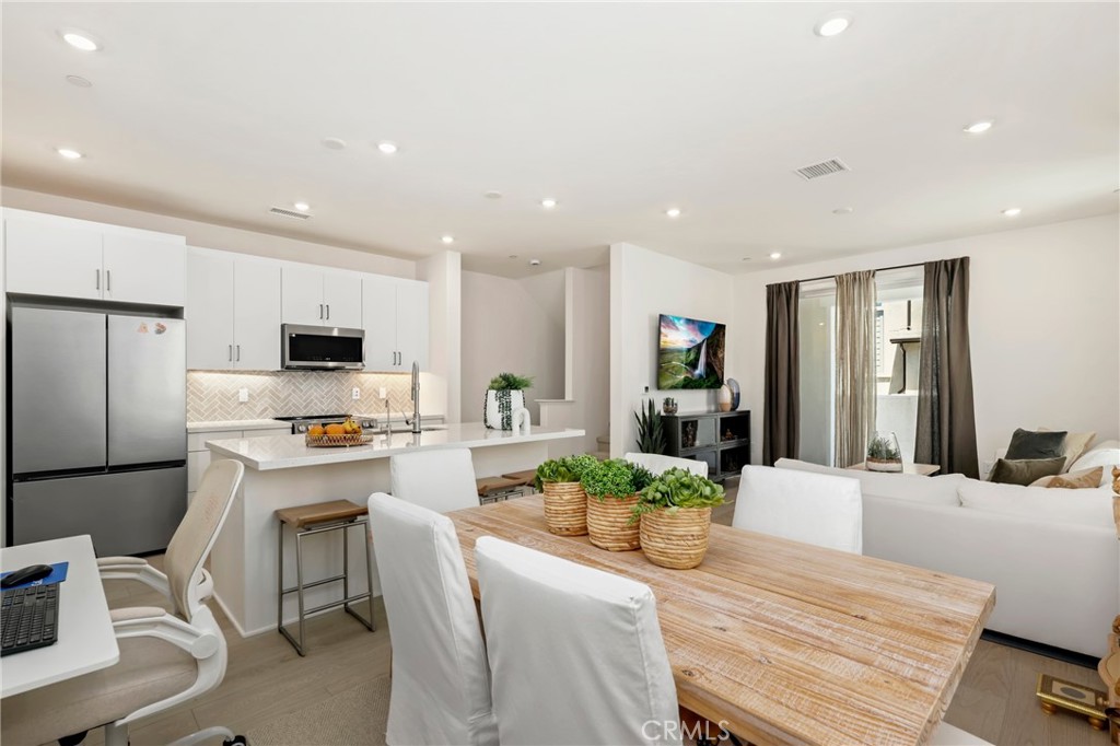 Welcome to luxury living at its finest in this stunning Plan One Heatherly home by Tri Pointe Homes! Perfectly situated to capture the essence of SoCal living, this three-level masterpiece offers a blend of modern elegance and functional design. On the first floor, discover a versatile living space that can double as an office or flex space, with direct access to the 2-car garage and a beautifully landscaped yard featuring newly installed turf—a serene retreat for outdoor gatherings under the California sun. The second level is the heart of the home, boasting an expansive great room where the living, dining, and kitchen areas seamlessly flow together. A spacious bedroom and full bath provide convenient accommodations for guests or family members. Ascend to the third level where luxury awaits in the form of a grand primary suite and a junior suite, each equipped with its own private bathroom. The primary suite is a sanctuary with a spa-like bathroom featuring dual sinks, an oversized step-in shower, and a generously sized walk-in closet. Throughout the home, enjoy the warmth of engineered hardwood flooring complemented by plush new carpet, enhanced by recessed lighting that accentuates every detail. Natural light floods the interiors, creating a bright and inviting atmosphere. The gourmet kitchen is a chef’s delight, showcasing white Shaker cabinets, quartz countertops, a stylish tile backsplash, stainless steel appliances, and a large eat-in island. A pantry closet provides ample storage space, ensuring both style and functionality. Experience the unparalleled amenities of Rancho Mission Viejo, including access to Ranch Camp, Ranch Cove community pool and gym, and a wide array of recreational opportunities. Residents also enjoy exclusive privileges across the Villages of Sendero, Esencia, Rienda, and future Villages—offering resort-style pools, fitness centers, community farms, playgrounds, and more. Embrace a lifestyle of luxury and convenience in this exceptional home, where modern comforts meet the vibrant community spirit of Rancho Mission Viejo.
