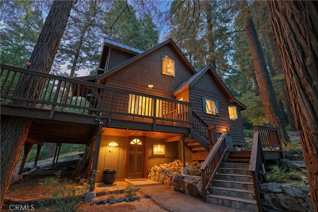 The cabin in the woods you'll always dreamed of. This nearly 100-year-old cabin tells a story with every beam and stone—yet it has been beautifully renovated for today’s lifestyle. Step inside and you’ll find the perfect blend of yesteryear charm and modern comfort. The original rock fireplace anchors the living space, while newer crank windows frame serene forest views.
The kitchen has been upgraded with modern, newly installed appliances, making cooking and entertaining a breeze while still preserving the rustic charm of the home.
The cabin sits on almost an acre of land, giving you privacy rarely found so close to the Village and Lake Arrowhead’s amenities.Lots of hiking trails just right outside. A sprawling Trex deck invites you to entertain or simply breathe in the quiet of the woods, with natural gas piped directly to the firepit, BBQ, and outdoor fireplace.
Modern upgrades include a metal roof, instant water heater, newer gas HVAC system, Generator,large laundry room, and plenty of storage. Thoughtful details make this home turn-key, and it even comes furnished and ready to enjoy from day one.
Whether you’re drawn by the history—imagining the countless memories made here over the past century—or the peaceful privacy of your own forest retreat, this home delivers both.
799 Crest Estates Drive is more than a cabin; it’s a piece of Lake Arrowhead history, reimagined for the next chapter. Seller is a licensed realtor.