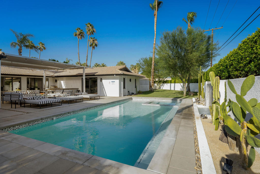 Looking for a stylish Palm Springs home ..... you found it! This modern Movie Colony home is loaded with a BBQ area, ping pong table, multi patio seating, fire pit for 8, large pool and spa, completely furnished 4 bed 4 bathroom, kitchen and open living space, fireplace in the living room, two car garage, and large driveway for additional parking. With a large grassy yard and multiple mature citrus trees, the property is just minutes away from Ruth Hardy park, shopping, dining, the casino, convention center, and downtown Palm Springs. Please call today for a private showing.