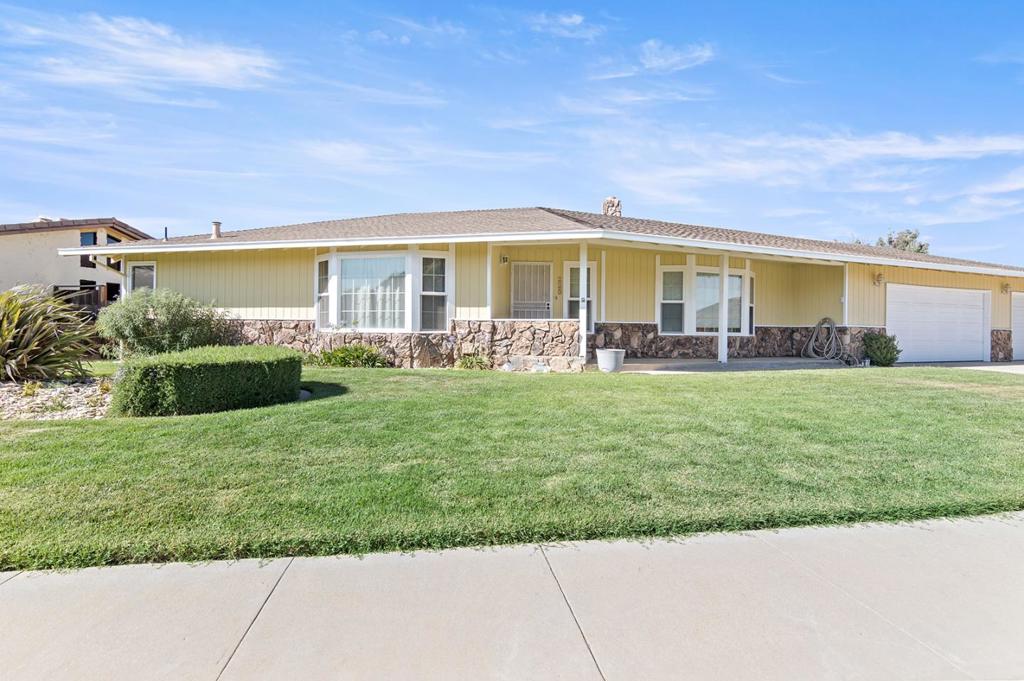 This inviting home offers both a living room and a family room with a cozy fireplace, giving you multiple spaces to relax and entertain. The kitchen features a generous pantry and opens to a dining room, perfect for gatherings. A bonus room with a wet bar that offers endless possibilities ideal for an office, entertainment space, or hobby room. Step outside to enjoy the large covered patio and grassy backyard perfect for barbecues, play, and relaxation. The property also boasts a three-car garage with a workbench for projects and storage. Located near restaurants, stores, parks, and the fairgrounds, with easy freeway access, this home combines comfort and convenience in one perfect package.