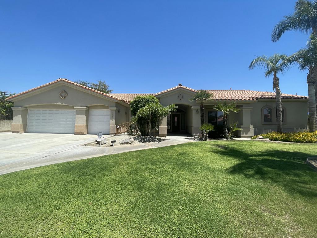 This stunning 3-bedroom, 4-bathroom home epitomizes elegance and comfort, blending luxury with modern amenities. The master suite features a spacious bedroom, a luxurious full bath with a soaking tub, dual sinks, and a walk-in closet. The two additional bedrooms each have their own ensuite 3/4 bathrooms, ensuring privacy and convenience for family or guests. An additional bonus office/library room has floor-to-ceiling cabinets/shelving with glass doors to view contents. A guest half bath is conveniently located near the front door.The grand open floor plan is highlighted by high ceilings and an elegant living room with a cozy fireplace. There are two dining areas, perfect for both formal and casual meals. The gourmet kitchen is upgraded with high-end appliances, a center island, and a hightop bar for additional seating. It boasts two dishwashers for easy cleanup and a wine cooler for the connoisseur.Step outside to an inviting pool with a waterfall feature and a spa Jacuzzi for ultimate relaxation. The grassy area is perfect for play or pets, and the built-in BBQ grill makes outdoor entertaining a breeze. Additional amenities include an extra room for laundry with a sink, a 2-car garage, and an extra garage space/door for a golf cart. The expansive driveway accommodates up to six additional guest vehicles, with a dedicated side area in the backyard perfect for a truck, larger vehicle or small camper.