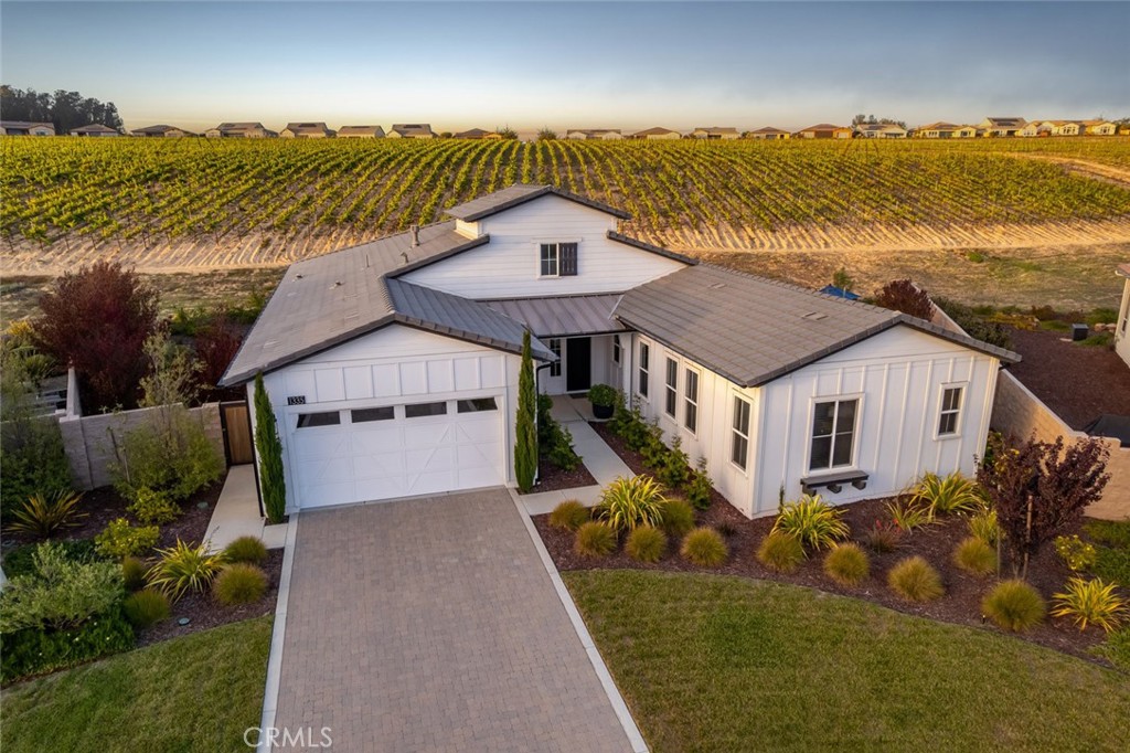 Flawless design. Urban vibe. A rare find. This nearly-new Carmel home has been artfully elevated to the next level. Beautifully situated deep within a cul-de-sac on an incredible pie-shaped lot and surrounded by vineyards and masterfully designed California native landscaping. It’s one of the most highly-sought-after models with 3 bedrooms, 3.5 bathrooms, including a casita. Built in 2021, at 2838 sq. ft., this meticulously curated transitional home features a great room, dining space and a gathering space with dual sided fireplace, shared with the den (currently an audio lounge with a moody vibe), and includes luxury engineered wood flooring, high-end custom light fixtures and mirrors, granite countertops, black Shaker-style cabinetry, and a rolling wall of glass so you can enjoy the view to its fullest extent. The kitchen is striking in all black - turn off the lights at night and the kitchen magically disappears into the shadows, making the great room much more intimate and inviting. Chefs and bakers will love the GE Profile stainless appliances including a 5-burner gas cooktop, double wall ovens, honed granite countertops and island with gorgeous pendant lighting. Adjacent, you’ll find the spacious laundry and a walk-in pantry. Entertaining couldn’t be easier, just slide open the wall of glass for a seamless indoor/outdoor experience, and enjoy the incredible view. The backyard offers an extended patio with a sleek built-in fire pit, two massive side yards and two raised garden beds, all in a natural setting with drip irrigation and a decidedly zen feel. Your private primary suite includes a spacious bedroom and luxury spa retreat with an amazing self-watering living wall, Roman tub, separate tiled shower with seamless glass enclosure, dual sinks with vanity, quartz counters, custom mirrors and lighting, linen storage and an outfitted walk-in closet. When friends and family stay over there’s a guest room with en-suite bath featuring specialty lighting, and a casita with a living room, bedroom, linen storage and a bathroom with shower - all with the same attention to detail as the rest of the home. Additionally, there’s an exquisite powder room, solar, and a 2-car garage with tankless water heater and EV charging plug. This one-of-a-kind home is located in Trilogy with Adelina’s Bistro, Sandalwood Spa, two golf courses, and so much more.