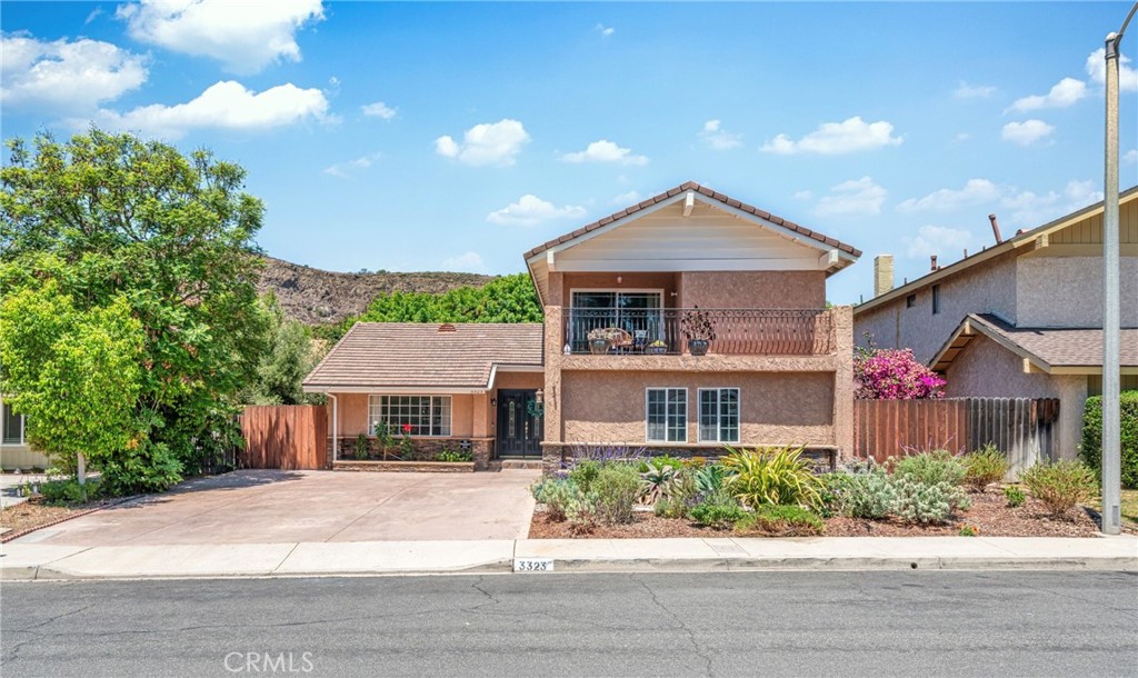 Welcome to 3323 Rainbow Creek Circle, a beautifully updated two-story home tucked in the highly desirable Wildwood neighborhood of Thousand Oaks. This 4-bedroom, 3-bathroom residence spans approximately 1,943 square feet and sits on a peaceful double cul-de-sac lot. Step inside to soaring ceilings, fresh interior paint, rich hardwood flooring, and an inviting open layout that flows seamlessly into a bright living room with a gas-start fireplace. The gourmet kitchen features granite countertops, stainless steel appliances, a breakfast bar, and charming country-style cabinetry. A flexible main-floor bedroom with an ensuite bath offers an ideal space for guests, a home office, or multigenerational living. Upstairs, the primary suite includes a private tile patio with serene mountain views perfect for enjoying your morning coffee or evening unwind. The private backyard boasts stamped concrete, lush landscaping, and space for entertaining or potential RV/toy storage. The attached two-car garage comes equipped with a built-in air compressor, making it perfect for hobbyists. Just minutes from hiking trails, including a scenic three-tier waterfall and paths to Malibu, and within close distance to Wildwood Elementary, Redwood Middle, and Thousand Oaks High School, this home offers the perfect balance of natural beauty, modern comfort, and suburban convenience. A rare opportunity in one of Thousand Oaks’ most cherished communities.