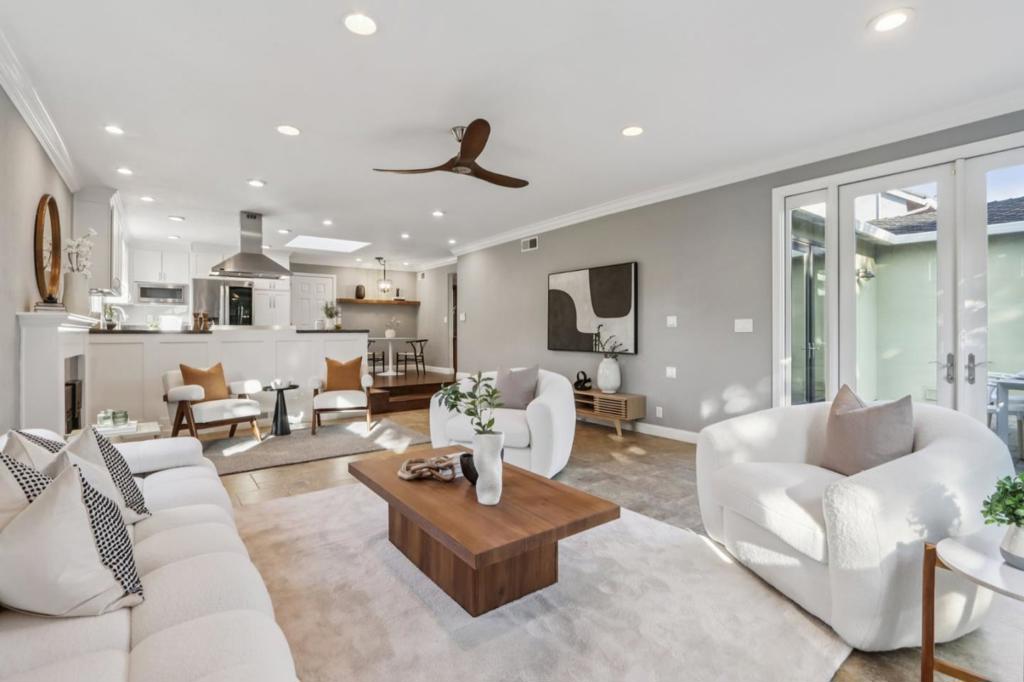 A sanctuary sculpted in warmth and radiance, this extensively remodeled home is a canvas of elegance and inspiration. Formal dining room awaits gatherings moments of laughter and heartfelt connection. Kitchen, a sunlit creative space, showcases a 6-burner gas range, LG Studio smart refrigerator, Bosch dishwasher, and GE Profile microwave, flowing seamlessly into the spacious living and family room, where a flickering fireplace and wide windows frame daylights gentle dance. French doors open to a backyard retreat with a paved patio, wood-fired pizza oven, and built-in BBQ where evenings linger like amber brushstrokes. A studio in the yard, bathed in calm, inspires creativity. Primary suite is a private haven with a walk-in closet and a spa-inspired bath, softened by natural light. Modern comforts include owned solar, dual-zone Nest A/C, wine cellar, a new reverse osmosis water system and softener, and more, blend seamlessly with timeless elegance. A soundproof garage studio/office for music/meditation, while at the front, a charming little library invites the community to pause and immerse in the magic of books. Surrounded by drought-tolerant landscaping, this home stands as a tranquil retreat where every corner invites peace, creativity, and connection.