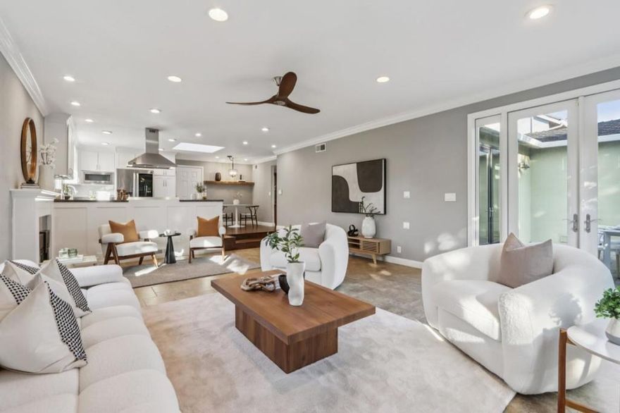A sanctuary sculpted in warmth and radiance, this extensively remodeled home is a canvas of elegance and inspiration. Formal dining room awaits gatherings moments of laughter and heartfelt connection. Kitchen, a sunlit creative space, showcases a 6-burner gas range, LG Studio smart refrigerator, Bosch dishwasher, and GE Profile microwave, flowing seamlessly into the spacious living and family room, where a flickering fireplace and wide windows frame daylights gentle dance. French doors open to a backyard retreat with a paved patio, wood-fired pizza oven, and built-in BBQ where evenings linger like amber brushstrokes. A studio in the yard, bathed in calm, inspires creativity. Primary suite is a private haven with a walk-in closet and a spa-inspired bath, softened by natural light. Modern comforts include owned solar, dual-zone Nest A/C, wine cellar, a new reverse osmosis water system and softener, and more, blend seamlessly with timeless elegance. A soundproof garage studio/office for music/meditation, while at the front, a charming little library invites the community to pause and immerse in the magic of books. Surrounded by drought-tolerant landscaping, this home stands as a tranquil retreat where every corner invites peace, creativity, and connection.