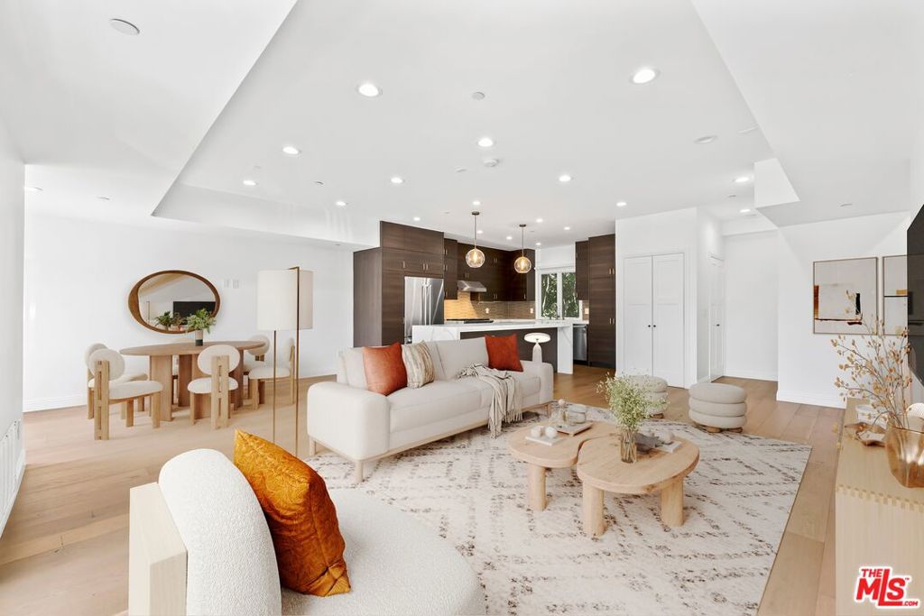 Experience modern living at this newer tri-level residence in the heart of West Hollywood. Built in 2021, the 3-bedroom, 2.5-bath home combines clean lines, natural light, and thoughtful design across more than 1,800 sq.ft. The open-concept main level features a chef's kitchen with Viking stainless steel appliances, Caesarstone countertops, custom cabinetry, and a wine fridge, all flowing into the dining area, living room, and balcony. Upstairs, the primary suite offers dual closets, a private balcony, and a spa-style bath with soaking tub, dual vanities, and a glass-enclosed shower. Two additional bedrooms share a Jack-and-Jill bath, while skylights and oversized windows bring warmth throughout. Other features include wide-plank French oak floors, in-unit washer/dryer, and central HVAC. A private, gated two-car garage with two storage rooms provides convenience and security. Just blocks from Melrose, La Brea, and Santa Monica Blvd., this home places you near some of the city's best cafs, shops, and nightlife, with easy access to studios and the Hollywood Bowl.