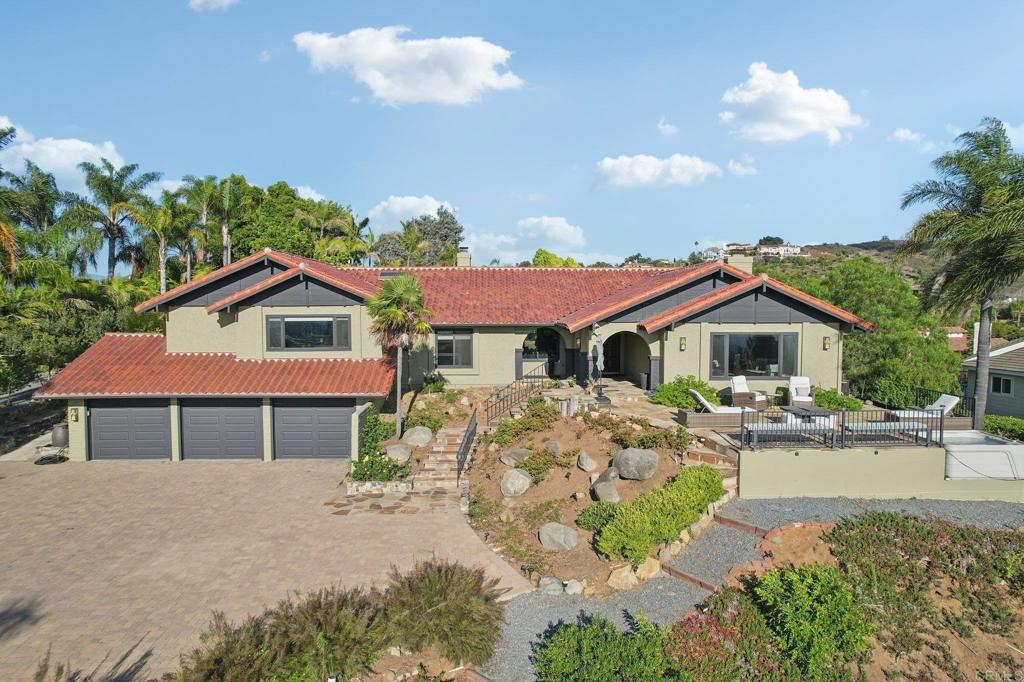 No Open House Sunday 07/27 Welcome to your dream retreat, perched in one of Vista’s most coveted neighborhoods, offering panoramic ocean vistas, rolling hills, and dazzling city lights. This meticulously upgraded and turnkey residence is a true sanctuary—designed for both everyday luxury and exceptional entertaining. Set on over an acre of beautifully landscaped grounds, this 4-bedroom, 2 full bath, 2 half bath home features expansive windows throughout, flooding the interior with natural light and framing uninterrupted coastal views. Soaring open-beamed ceilings, rich moody accents, and two wood-burning fireplaces create a sophisticated and inviting atmosphere. The gourmet kitchen is a showstopper—equipped with a Viking cooktop, double convection oven, and a custom 9-foot walnut island that perfectly complements the matching handcrafted dining table. Entertain effortlessly indoors or out, with custom stonework and hardscaping that elevate every corner of the property. Enjoy modern convenience with owned solar, a Google Smart Home system with wall-mounted control panel, smart TVs, a high-end video security system, and keyless entry. The oversized finished 3-car garage adds functionality and storage. Outside, this gated estate features a producing vineyard with Cabernet and Syrah grapes—complete with Italian harvesting equipment—and an array of fruit and nut trees for your own farm-to-table experience. Tucked away in a peaceful setting yet just minutes to downtown Vista and major freeways (78, 5, and 15), this home offers privacy without sacrificing convenience. A rare opportunity to own a custom ocean-view estate that truly has it all—schedule your private tour today!