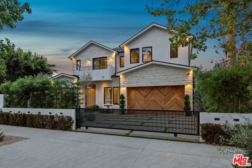 Spectacular custom-built home situated within the highly desirable area of studio city. Boasting 5BD/6.5BA this home has been meticulously designed to perfection and built with only the finest of finishes. Upon entering you'll be greeted by seamless oak flooring and an abundance of natural light. The chef's kitchen is a culinary masterpiece featuring a generously sized island, white oak cabinetry, glistening calacatta countertops, Thermador appliances, walk-in pantry, and a seamless connection to the living room. The expansive living room showcases a marble  custom arched built-ins, and aluminum pocket doors that open up to the resort-like backyard, creating a seamless indoor-outdoor lifestyle. On the lower level there is an ensuite guest bedroom as well as a powder room for added convenience. Upstairs the exquisite master suite serves as a peaceful oasis with a cozy fireplace, a large walk-in closet, and balcony overlooking the backyard. The opulent master bath resembles a spa retreat with its soaking tub, shower, dual vanities with travertine stone. Additionally there are three more ensuite bedrooms upstairs along with a laundry room. The expansive backyard is surrounded by beautiful landscaping, tall fence ensuring privacy, and features a refreshing pool/spa and ample space for entertaining.  Great pool house that feature a gym and amazing basketball court, as well firepit area and outdoor kitchen. Nestled within the highly sought-after tujunga village neighborhood. welcome!