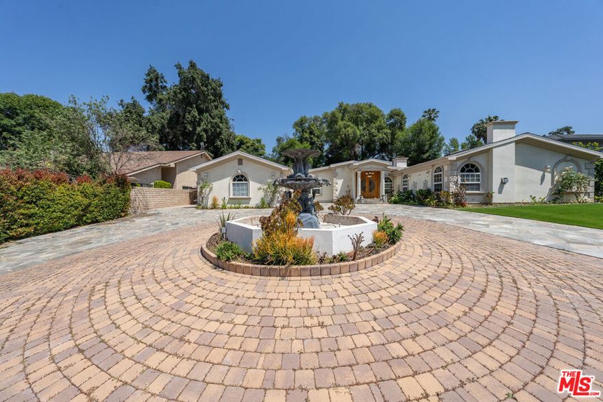 Beautiful single-story pool home in one of Calabasas' most desirable neighborhoods within the Las Virgenes Unified School District. The main house offers 3,976 sq ft of living space with 4 spacious bedrooms and 3.5 baths, featuring travertine flooring, vaulted ceilings, and a chef's kitchen with granite countertops, a 60" Wolf dual-oven range, and built-in refrigerator. Recent upgrades include 34 fully paid-off solar panels and a new roof (2022). A separate ADU/guest house with its own address, parking, EV charger, kitchen, and laundry provides excellent flexibility for guests or rental income. The property sits on a 13,000+ sq ft lot with a circular driveway, multiple EV chargers, lush green space, fruit trees, and an entertainer's backyard complete with a sparkling pool/spa, fire pit, and seating area. Close to top-rated schools, freeway access, shopping, and dining.