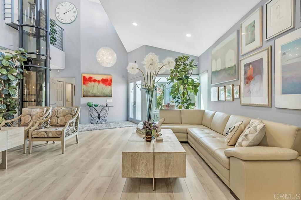 This magical residence features the desirable San Remo floor plan where luxury, beauty, and elegance blend seamlessly. Every detail of this breathtaking remodel has been meticulously crafted, including a state-of-the-art PVE (Pneumatic Vacuum) Elevator providing ease and convenience. As you enter, you are welcomed by dramatic high ceilings and an abundance of natural light, all highlighted by an exquisite chandelier which sets the stage for the homes dramatic allure. The formal living area features a stylish bar with onyx counters, built-in wine racks & custom cabinetry, and LVP flooring alongside a formal dining room perfect for gatherings. The kitchen is a chef's dream, with custom European-style cabinetry, onyx countertops, and top-of-the-line stainless steel appliances, including a brand-new Sub-Zero fridge/freezer, Bosch dishwasher, and KitchenAid ovens and cooktop. Enjoy the sunny breakfast area or relax in the great room by the fireplace adorned with floor-to-ceiling tile and an onyx mantel. The main level also includes an ensuite bedroom and remodeled bathroom in addition to a stunning half bathroom with Vetrazzo tile and a glass vessel sink. The elegant staircase, with its contemporary metal railings and imported Lalique Italian chandelier, leads to the expansive primary suite which offers soaring ceilings, custom cabinetry, a walk-in closet with tailored built-ins, and a private balcony with lovely neighborhood views. The primary bathroom has been transformed into a haven with dual sinks, an expansive walk-in shower with floor to ceiling wave gris tile, and tasteful porcelain flooring. An additional en-suite bedroom and bathroom make it welcoming for guests. Both the front and rear yards have been reimagined with new hardscape and lush landscaping, creating a peaceful and private oasis. Additional details: Newer furnace and AC, home water filtration system, home air filtration system, security system, new windows, doors, and screens, as well as newer plumbing and electrical. The interior is also complemented by newer engineered wood flooring and ultra plush carpet. Nestled atop a hill beside a nature preserve, Ocean Hills Country Club offers an elevated lifestyle within its premier 55+ community. Encompassing eight villages and 1,632 homes, the club provides an array of amenities with over 40 social clubs and activities, an 18-hole executive golf course, pickleball, tennis courts, gyms, a clubhouse and lounge, RV gated parking (subject to availability), a dog park, and a butterfly sanctuary accredited by the "Save the Monarch Butterfly Foundation”, and so much more! Living in the Ocean Hills Country Club offers an exceptional lifestyle, providing something for everyone to enjoy.