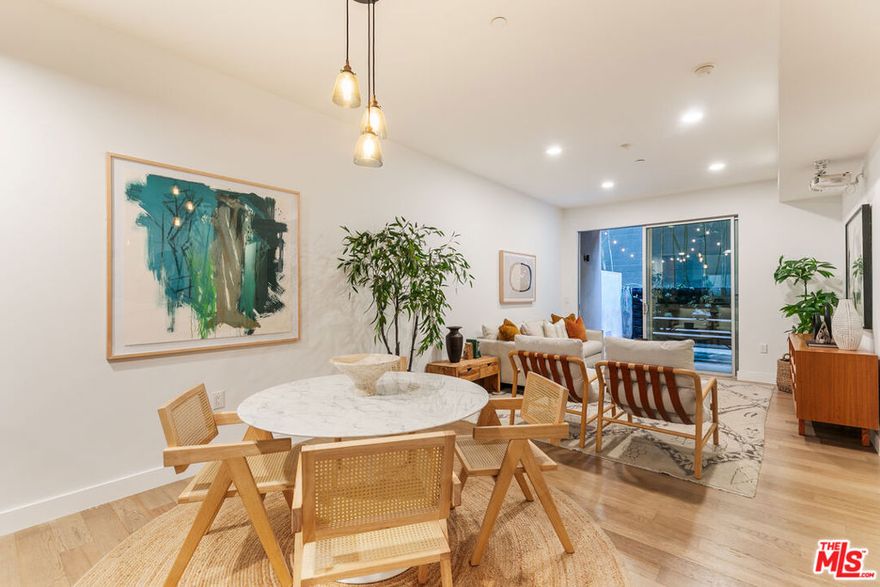 Experience modern luxury in the heart of Hollywood. This stunning 2-bedroom, 2-bathroom condo blends style, comfort, and sophistication with an open-concept layout designed for today's lifestyle. The high-end kitchen with an island anchors the main living space, seamlessly connecting the built-in office area, dining nook, and living room.  Step outside to your private outdoor patio, an expansive retreat ideal for entertaining or dining al fresco. Both bedrooms are generously sized with tall ceilings and ample closets, while the primary suite offers a spa-like escape complete with a rainfall shower and soaking tub.  Additional highlights include in-unit laundry, outdoor storage, and two tandem parking spaces.   Enjoy resort-style amenities with a state-of-the-art fitness center, EV charging, ample guest parking, secure entry, and an unbeatable location close to everything Hollywood has to offer. Spend Sundays at the Hollywood Farmers Market, catch a show at The Fonda Theater, and explore endless dining and shopping options. All just minutes away. Conveniently located near major studios and offices like Netflix, this home combines the best of city living with modern comfort and privacy.  Modern design, luxury finishes, and prime location, this is Hollywood living at its finest.