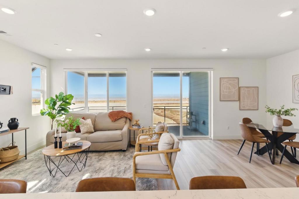 Discover modern living at 9608 Seawind Way in Newark, CA. This beautifully designed 2-bedroom, 2-bath townhouse features an open-concept layout with abundant natural light, a stylish kitchen with contemporary finishes, and a spacious private deck perfect for relaxing or entertaining. From the patio, enjoy serene views overlooking the San Francisco Bay, where stunning sunsets paint the sky with vibrant colors each eveningan ideal backdrop for quiet evenings or hosting guests. Built in 2022, the home also includes a 2-car attached garage and is located in a vibrant community with easy access to parks, schools, shopping, and major commuter routes. A perfect blend of comfort, style, and breathtaking views.
