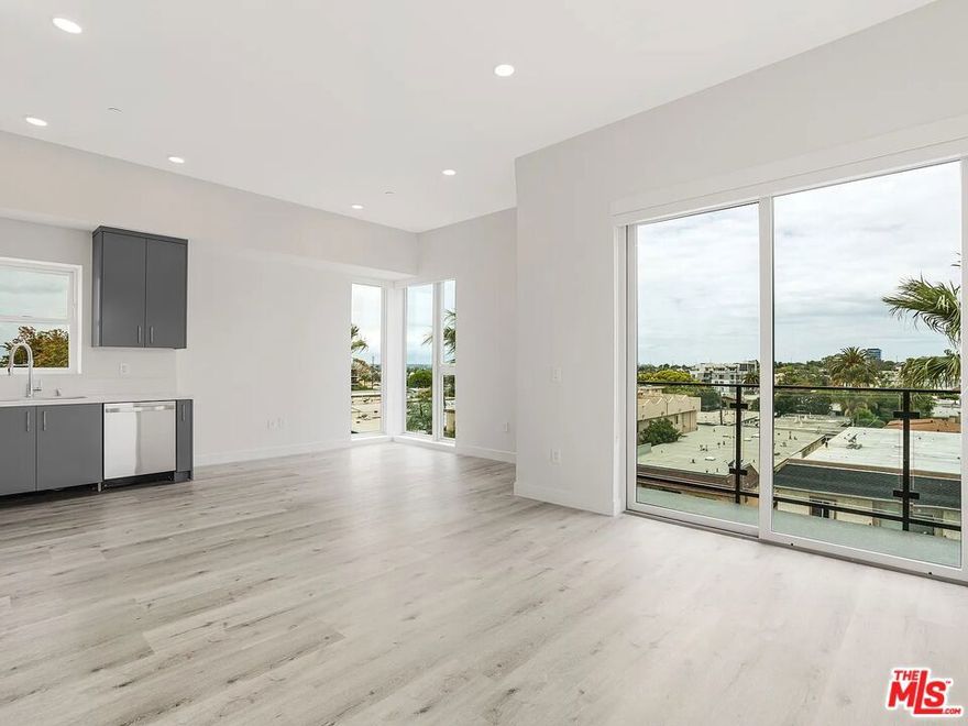 Top-floor living at The Jade of Palms. This modern penthouse features high ceilings, big windows, and a private terrace with city views. The open layout includes a sleek kitchen with stainless steel appliances, in-unit washer and dryer, and two full bathrooms. The building offers secure entry, gated parking with EV charging, and a rooftop deck perfect for relaxing or entertaining. Close to shops, restaurants, and transit, it's an easy place to settle into Westside living.