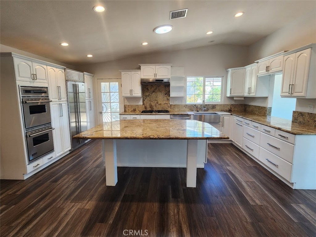 Welcome to a beautiful South of the Boulevard home with 4 bedrooms, 3 bathrooms, nearly 2400 square feet, and a beautiful VIEW from almost every room in the house. Your new home features an amazing chef's kitchen with Viking appliances, Subzero fridge, granite counters, custom white cabinets, and a huge center island. Other features include wood laminate flooring, recessed lighting, vaulted ceilings, eat-in kitchen, dining room, living room with fireplace, inside laundry room, tankless water heater with recirculating hot line, dual A/C systems, and an attached 3-car garage with direct access. Downstairs are 3 bedrooms and a bathroom with dual sinks and a tub / shower combo. The primary suite is upstairs with a large walk-in closet and a spacious en-suite bathroom with dual sinks, vanity, and step-in shower. Outside enjoy the amazing VIEW from your two large patio areas and garden. Schools are Calabash, Hale, and El Camino Real. Close to Ventura Blvd, the Calabasas Commons, and the Village Topanga.