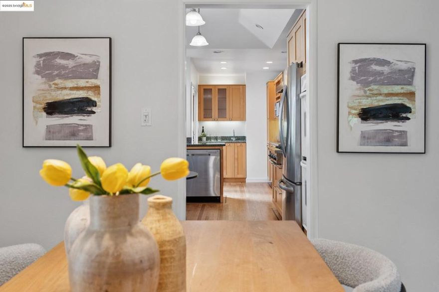 Modern convenience, elegance, and an open floor plan in this updated Upper Rockridge Traditional home. A bright living room welcomes you in, with a cozy fireplace, refinished hardwood floors, and an expanse of windows overlooking the neighborhood. A chic, updated, eat-in kitchen, custom maple cabinetry, and bar area with wine fridge and sink, with sliding glass doors to a sweet back deck, perfect for morning coffee.  A front-facing bedroom with loads of sunlight, a renovated marble and tile bathroom, and a primary bedroom that opens to an enormous backyard. Downstairs, you’ll discover the original third bedroom and a Wine Cellar!  Custom-built with oak panels, wine racks, William Morris-style wallpaper, a vintage door, and even a hidden safe.  It’s like a step through time and just so cool!  You’ll also find a full bathroom, a laundry room, and a bonus room, all perfect for a guest or au-pair suite. Two-car garage and utility room.  Landscaped front yard, and private backyard ideal for indoor/outdoor entertaining and play!  Just up the street from the Village Market, convenient to Hillcrest to Hillcrest and private schools, College Ave shops and restaurants, AC Transit bus lines, Rockridge BART, Lake Temescal, Montclair Village, and more.