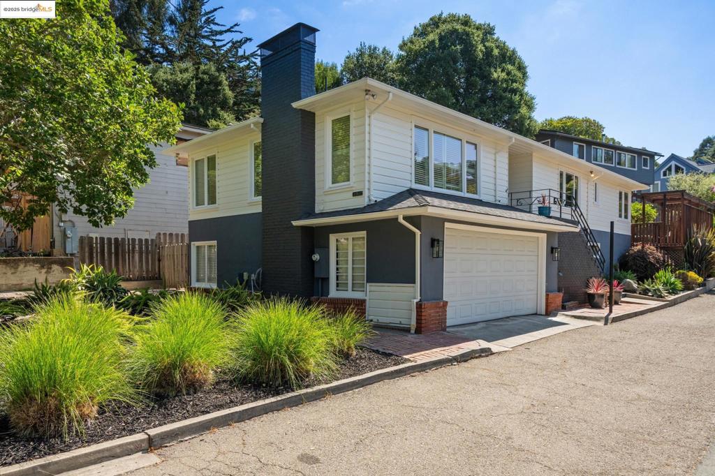 Modern convenience, elegance, and an open floor plan in this updated Upper Rockridge Traditional home. A bright living room welcomes you in, with a cozy fireplace, refinished hardwood floors, and an expanse of windows overlooking the neighborhood. A chic, updated, eat-in kitchen, custom maple cabinetry, and bar area with wine fridge and sink, with sliding glass doors to a sweet back deck, perfect for morning coffee. A front-facing bedroom with loads of sunlight, a renovated marble and tile bathroom, and a primary bedroom that opens to an enormous backyard. Downstairs, you’ll discover the original third bedroom and a Wine Cellar! Custom-built with oak panels, wine racks, William Morris-style wallpaper, a vintage door, and even a hidden safe. It’s like a step through time and just so cool! You’ll also find a full bathroom, a laundry room, and a bonus room, all perfect for a guest or au-pair suite. Two-car garage and utility room. Landscaped front yard, and private backyard ideal for indoor/outdoor entertaining and play! Just up the street from the Village Market, convenient to Hillcrest to Hillcrest and private schools, College Ave shops and restaurants, AC Transit bus lines, Rockridge BART, Lake Temescal, Montclair Village, and more.
