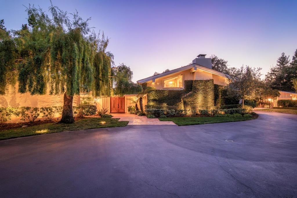 Your dream compound and playground on nearly 2 private acres with spectacular western hill views on the prestigious west side of Atherton. Balancing the conveniences of comfortable daily living with opportunities for grand scale entertaining, the main residence is a Spanish-inspired retreat, with a sprawling one level floor plan organized around a central courtyard. The home's interior is awash in natural light from expansive floor-to-ceiling windows, skylights, and cathedral ceilings. Outside, the meticulously landscaped grounds provide endless opportunities for recreation and relaxation. Enjoy the gated pool, putting green, sports cage and multiple entertaining and dining areas. The detached pool house and well-appointed guest house offer additional accommodations, perfect for extended stays or use as a gym or home office. Two garages provide both daily access convenience and extra space for additional vehicles or storage. The park-like setting, with its stunning views, mature trees and vibrant flowers offers endless possibilities to enjoy as is or enhance with remodeling. A tranquil oasis that feels far from the hustle and bustle, yet is conveniently close to the coveted Las Lomitas school district, Hwy 280, Stanford University, Silicon Valley employers and local services.