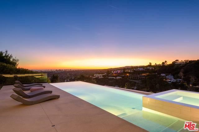 Located high atop the exclusive Oriole Way in the Bird Streets, a star-studded neighborhood only minutes from Beverly Hills and the Sunset Strip, this immaculate contemporary masterpiece offers an unparalleled luxury environment. The panoramic view spans the entire LA skyline, stretching all the way to the Pacific Ocean. Impressive 2000 sq ft master suite has an enormous walk-in closet along with five other bedrooms and ten bathrooms. The outdoor area includes opulent landscaping, a full outdoor kitchen, and an infinity pool overlooking all of LA, making this a perfect place for entertaining. The property also includes a spa, gym, and a massive movie theater, creating a tranquil compound in the midst of the best part of Los Angeles.