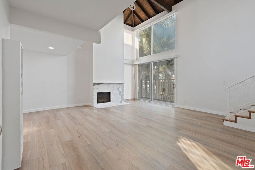 Fully Remodeled - Top-Floor - 2 Bedrooms + 2 Baths + Loft + Roof deck + 3 Balconies with hardwood floors, custom Kitchen and gorgeous bathrooms.  Just steps from the Venice Canal and only one block from the beach and Washington Square's dining and shopping. Enjoy soaring, dramatic two-story wood-beamed ceilings and floor-to-ceiling windows that fill the space with natural light. The light and bright kitchen is fully stocked with ample cabinet and counter space, along with a refrigerator, oven/range, microwave, and dishwasher, and opens to the expansive dining and living areas showcasing a cozy stone-surround fireplace and oversized windows. Plush carpeting and recessed lighting throughout add warmth and comfort to the space. The large primary bedroom features an ensuite bathroom and a private balcony, while the second bedroom has plenty of closet and storage space, easy access to the hallway bathroom, and its own balcony as well. The extra-large, second-floor loft is complemented with a wrought iron railing detail and beautiful vaulted wood-beamed ceilings, offering a wonderful bonus flex-space and recreational area great for a home office/studio, gym, and/or guest quarters, and provides direct access to the rooftop deck perfect for seamless indoor-outdoor flow. With two-car tandem outdoor parking included, on-site shared laundry, and a vibrant surrounding neighborhood with endless options for entertainment and popular local amenities, this coastal retreat is ready to welcome you home!