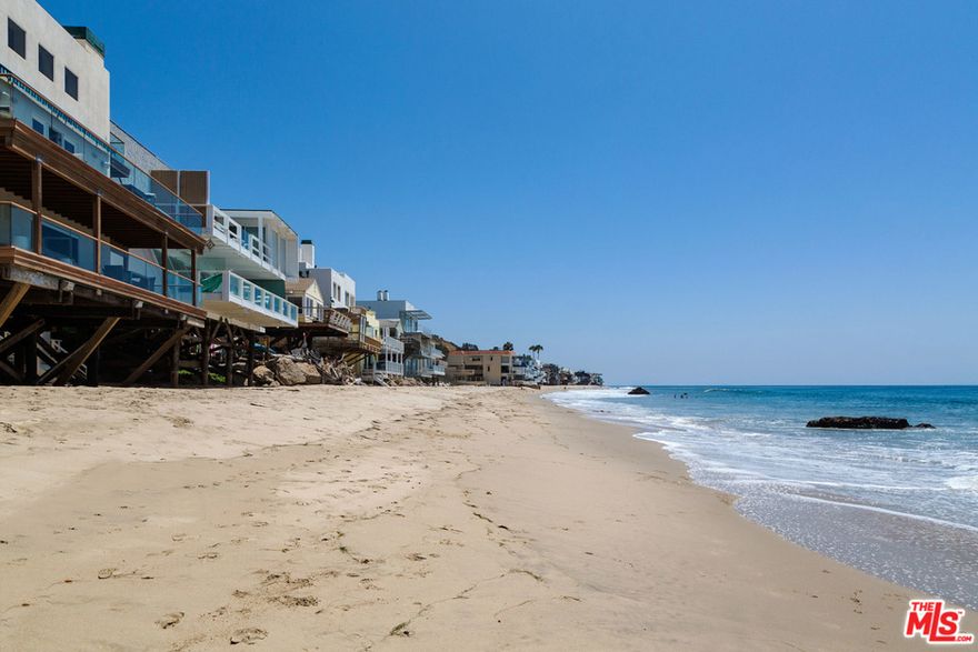 Beautiful contemporary beach house on a great sandy section of Malibu Road. Large entryway leads to the spacious two-story oceanfront living room and dining area with fireplace. Gourmet kitchen with stainless steel appliances and Viking oven and range. Floor-to-ceiling windows opening to expansive oceanfront deck with new electric awnings and direct stairs to the beach. Oceanfront master suite on own level with wide plank oak floors and fireplace, luxurious bathroom and walls of glass opening to a private oceanfront deck. Two additional bedroom suites plus a maid's or fourth bedroom with bathroom and separate entrance.