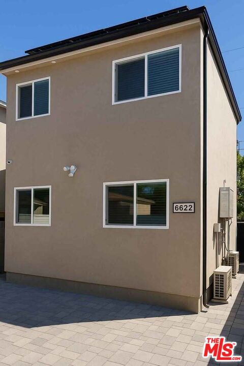 Welcome to effortless modern living in this newly built, energy-efficient townhome. Rich wide-plank floors ground an open concept plan where a crisp white palette is punctuated by charcoal cabinetry and stainless steel appliances, all softly lit by under-cabinet LEDs. Slide open the patio door to enjoy morning coffee on your private, low-maintenance paved courtyard. Upstairs, the generous bedroom is washed in natural light and anchored by a fully built-out walk-in closet of warm walnut tones. The en-suite bath pampers with floor-to-ceiling marble-look tile, a frameless glass door, rainfall head and built-in bench. A convenient guest powder room, in-unit laundry hookups, ductless mini-split HVAC, dual-pane windows, tankless water heater and owned rooftop solar keep comfort high and bills low. All this in roughly 800 sq ft of meticulously planned spaceminutes from dining, shopping and commuter routes.