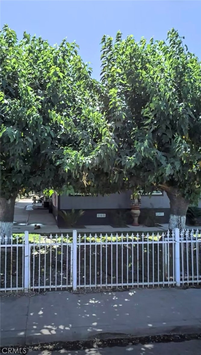 This manufactured home sits on its own lot with a permanent foundation. 2 Bedrooms and 2 Bathrooms plus an additional toy / office room. Open floor concept, family dinning room. Beautiful remodeled kitchen with island, quarts counters. Inside laundry plus central AC. Plenty of shade and fruit trees. Possible ADU and RV access with 2 cover carports. Metal fence with electric remote control opener. Selling as-is!