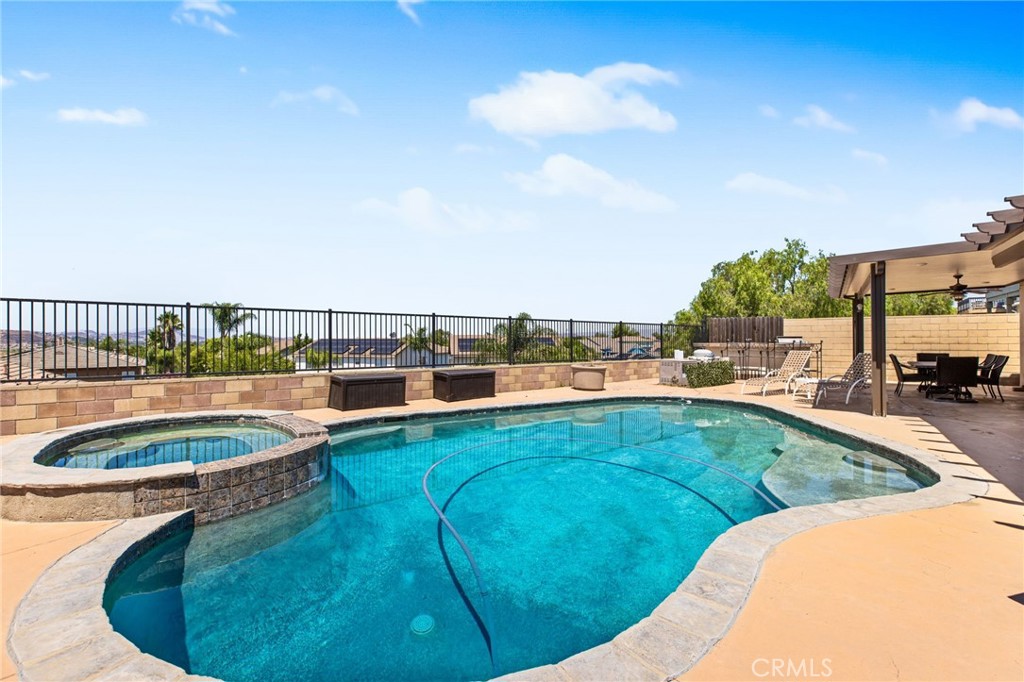 Welcome to this stunning 2,808 Sq Ft SINGLE-STORY HOME with a VIEW, built in 2006, offering the perfect blend of comfort, style, and functionality. Nestled on a generous 7,840 Sq Ft lot, this 4-bedroom, 3 full-bathroom home features an open and inviting floor plan ideal for both entertaining and everyday living. Step inside to discover upgraded flooring throughout, custom paint colors that add warmth and personality, and a beautifully designed decorative fireplace with a mantel—perfect for cozy evenings. The chef’s kitchen and large living spaces seamlessly flow together, creating a spacious and connected feel throughout the home.
Enjoy year-round comfort with dual central air conditioning units, and energy-efficient solar panels. The oversized 3-car garage includes a tandem space, providing ample room for vehicles, storage, a workshop, or even an office!
Step outside to your own private backyard oasis featuring a sparkling pool and spa—perfect for relaxing or hosting guests.
Located in a desirable neighborhood in Menifee, close to parks, schools, shopping, and more. This home has it all—space, style, and a resort-like outdoor retreat!
Don’t miss your chance to own this incredible one-story pool home!