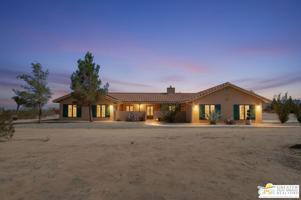 A luxury desert oasis unmatched at this price! CHECK THE COMPS... They average over $300 per ft. THIS IS A SMOKIN DEAL. Located on 2.4 acres this home has privacy. Built in 2007 this custom home has it all. An amazing floor plan with formal living and dining rooms. A large kitchen opens to a family room with beautiful stone fireplace. A split floor plan with the primary suite on one side with two bedrooms with an office on the other side of the home. An oversized garage that could accommodate 3-4 cars. Outside there is an entertainer's paradise featuring a pool/hot tub, covered patio with BBQ, firepit sitting area. There is an 16x40 RV garage perfect for contractors or car collectors. The property is close to Joshua Tree Village and the National Park. Solar will be paid off with an acceptable offer. Some photos are virtually staged. Property is only .3 of a mile off a paved road.