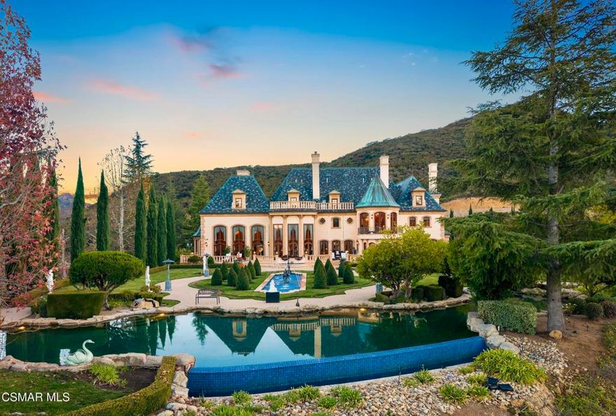 Chateau Plaisance, a CASTLE nestled within the prestigious 24/7 guard gated Sherwood Country Club, spans nearly 3 private acres across 5 lots, offering breathtaking views of the spectacular Santa Monica Mountains and the renowned Jack Nicklaus Signature Golf Course. Perfected in every detail, this approx. 14,113-square-foot French-inspired masterpiece showcases unparalleled artisanship and timeless elegance.The Castle's park-like grounds are a true masterpiece, featuring formal box-hedged gardens filled with thousands of roses, lush lawns adorned with life-sized statuary, and cobblestone pathways leading to a striking 52-foot reflection pond where bronze horses appear to gallop through cascading water. A serene large infinity pool and spa with a waterfall, a koi pond, and an ornate iron gazebo overlooking the valley complete this enchanting outdoor retreat.A grand entrance welcomes you into the rotunda, where a dazzling Baccarat chandelier, hand-painted murals, and a sweeping marble staircase with a gold-leafed iron banister set the tone for the opulence within. The 22-foot-high Grand Salon & Ballroom boasts two Spanish brass and crystal chandeliers, a carved fireplace, and towering windows that frame the gardens. An elevated alcove provides the perfect stage for entertainment.The richly paneled library, complete with parquet flooring, a fireplace, and a hidden bar, offers a cozy escape, while the formal dining room, seating 20, is illuminated by two custom Waterford chandeliers. The gourmet kitchen, adorned with antiqued cabinetry, parquet flooring, four subzero refrigerators, and two oversized islands, opens to a warm and inviting family room featuring a grand fireplace, elegant window seating, and a granite-topped bar.The second floor offers a luxurious primary suite with a sitting area, fireplace, a sleek wet bar, and two lavish spa-inspired baths with oversized closets. Additional guest suites, a Carriage House apartment, and a hidden third-floor bonus space provide ample accommodations. The completed third floor features four separate rooms, providing endless possibilities for a home theater, gym, art studio, or private retreat.This Castle also includes a Pool House--a Mini Chateau with a great room, grand fireplace, kitchen, and two bathrooms, perfect for poolside entertaining. Two gated entrances lead to an elegant courtyard with an imported French fountain, while a separate guest parking area and the Grand Plaza can accommodate up to 150 guests.Gated guest parking is conveniently located near the charming greenhouse and the elegant archway leading to the Grand Plaza, designed to accommodate approximately 150 guests with ease. Chateau Plaisance Castle stands as a pinnacle of luxury, privacy, and grandeur--an estate unlike any other to ever grace the market.