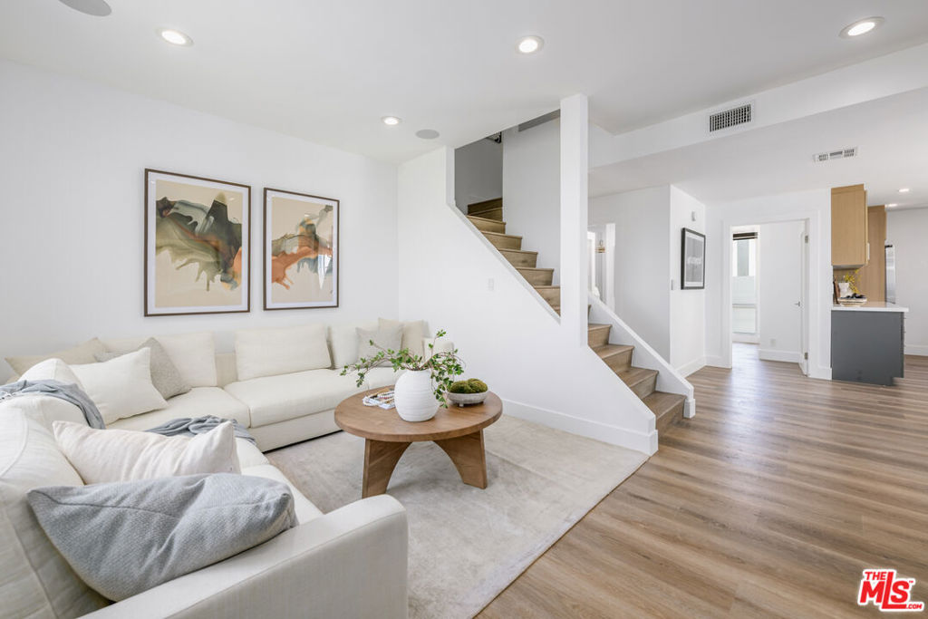 Ideally located in prime Echo Park, this thoughtfully updated townhome-style, 3-story unit offers 3 bedrooms + Office/4th bedroom, 3 baths across 1,511 square feet of open living space. With new flooring, high ceilings, and sunlight streaming in from every angle, the home offers comfort and the best of Echo Park living just moments from its best commercial and recreational offerings like Eightfold Coffee, Tsubaki, Eastside Deli, and the trails of Elysian Park. The gorgeous corner unit is located in a rare gated community that offers sweeping and iconic downtown and mountain views and is down the street from quaint Everett Park. The home's front door opens to the main level, where you will find a spacious living area, a brand new kitchen outfitted with stainless steel appliances and ample cabinetry and a large guest bedroom and bath. Your private two-car garage opens to the home's first level and the huge office/gym which doubles as a perfect 4th bedroom. On the 3rd level find 2 huge en-suite bedrooms, including the Primary which has dramatic views of the mountains and Dodger Stadium, a generous walk-in closet and a bathroom with dual vanities and thoughtful finishes. On the top level is the private roof top deck with dazzling 270 degree views where you can lounge and unwind. Perfectly situated in Echo Park's coveted commercial district near Elysian Park, and just minutes to Silver Lake and Downtown, this home offers unbeatable access to Eastside favorites. Central Air throughout with mini-split for office space. 9 guest parking spaces. Whether you're hitting the trails at Elysian Park or strolling to Guisados, you're right where you want to be.