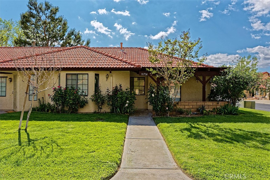 Huge Price Reduction!! DESIRABLE JESS RANCH CONDO FOR SALE!! Freshly remodeled 2 bedrooms, 1.5 baths, 977 square feet of living space with enclosed and covered dedicated carport for parking. Corner lot home provides peace and privacy. Located in desirable Jess Ranch, a 55+ resort style living plan development!! Open floor plan with high vaulted beamed ceiling, natural sun light through larger windows create an open, airy, cozy & roomy feel to the home. The kitchen is equipped with a built-in microwave and oven, while the stackable washer and dryer add to the home’s convenience. The Primary master bedroom features a spacious walk-in closet has built-in skylight. Residents of this condo will soon enjoy a brand-new clubhouse with a pool / jacuzzi, club house community gatherings. Conveniently located walking distance from Jess Ranch Marketplace mall: all types of shopping, restaurants, Cinemark movie theater, a golf course, and much more. Luxury amenities includes: a sparkling pool, spa, club house and 24/7 security gate with guard and patrol. Park like landscaping with lush green real grass, mature trees, flower shrubs and garden.