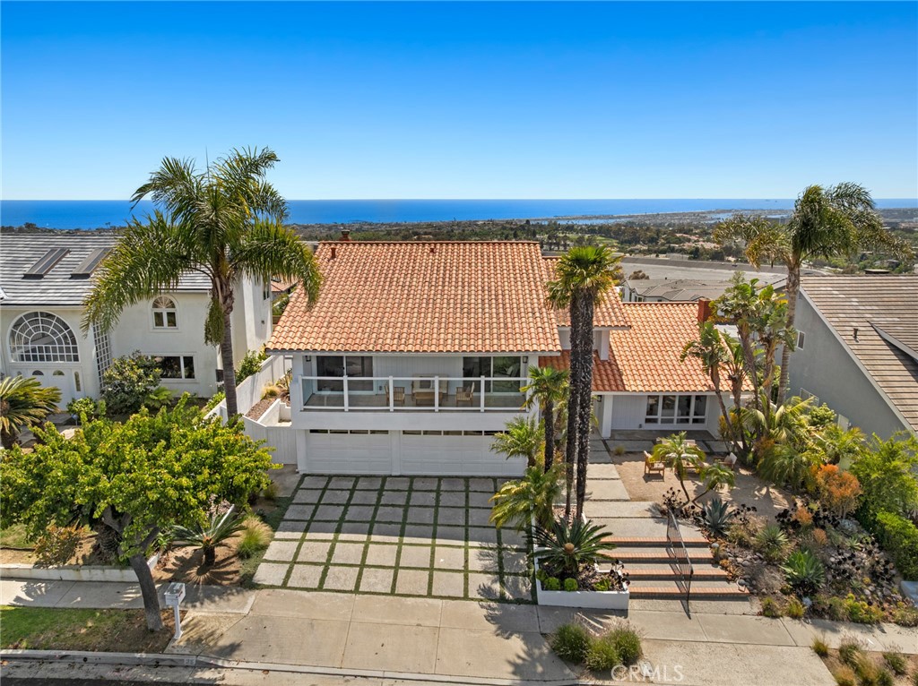 Now available for lease in the highly sought-after community of Spyglass Hill, 25 Point Loma Drive showcases sweeping, unobstructed views of the Pacific Ocean, Catalina Island, and the sparkling lights of the Newport skyline. This 4-bedroom, 3-bathroom home offers an elegant yet comfortable floor plan filled with natural light and coastal charm.
A dramatic spiral staircase makes a striking first impression upon entry, leading to a series of inviting formal and informal living spaces—each centered around a cozy fireplace. The updated kitchen connects effortlessly to the dining and family areas, all opening to an expansive front patio ideal for year-round outdoor living, featuring a built-in firepit, tranquil fountain, and shaded lounge area.
Upstairs, the ocean-view primary suite includes its own private deck, spa-like bath with soaking tub, walk-in shower, dual sinks, and generous closet space. Two additional bedrooms, one with direct deck access, plus a spacious den or flex room, provide versatile living options. The main level includes a bedroom and full bath—perfect for guests or a home office—along with a laundry room and an attached 3-car garage.
Centrally located just minutes from world-renowned beaches, upscale shopping and dining at Fashion Island, and top-tier golf, this is a rare opportunity to lease a view property in one of Newport Beach’s most prestigious neighborhoods.