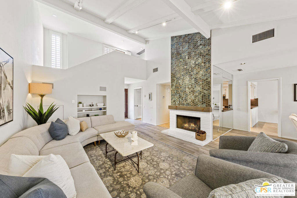 Experience desert living at its best at 38 Tennis Club Drive, in the sought-after Rancho Mirage Racquet Club. Featuring the community's largest floorplan, boasting over 2,300 square feet, this rarely available, beautifully updated home offers three bedrooms and three full bathrooms, including two spacious en-suites and a third bedroom with full bath downstairs. Throughout, enjoy serene views of the lake, waterfall, and surrounding mountains. Inside, soaring ceilings, fresh paint, and new flooring create a bright, inviting atmosphere. The living room boasts a gorgeous, tiled fireplace and stunning lake and waterfall views, while the modern kitchen offers stainless steel appliances, granite countertops, and a sunny breakfast room. Adjacent to the dining area, a wet bar with sink and cabinetry makes entertaining effortless. Panoramic mountain vistas can be seen from the front of the home and one of the two oversized en-suite bedrooms, while multiple patios provide ideal spots for relaxing or dining al fresco. An abundance of closet space is a welcome feature. A newer HVAC system ensures comfort year-round, and a private two-car garage plus driveway parking add convenience and security. Residents of this gated enclave of just 95 homes enjoy five pools, five spas, tennis and pickleball courts, a fitness center, clubhouse, putting green, and beautifully landscaped lakes, waterfalls, and streams. Perfectly situated near shopping, dining, golf, and hiking, this home is ideal as a full-time residence, vacation retreat, or investment opportunity. Schedule your private tour today and discover the exceptional lifestyle at 38 Tennis Club Drive!