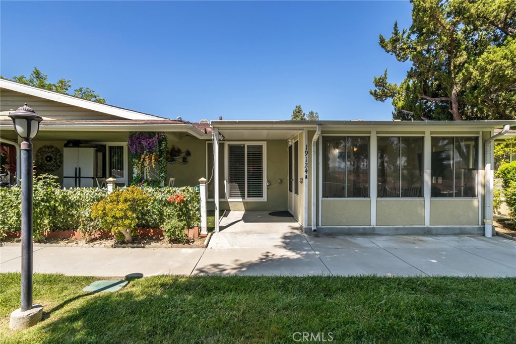 Welcome Home! That's the warm greeting you'll receive upon entering the gate of this vibrant 55+ active community. Relax and enjoy the privacy of the enclosed patio which overlooks a lush greenbelt with peek-a-boo mountain views. Inside you're welcomed by a beautifully tiled open floor plan with high ceilings and recessed lighting, which continues throughout the home creating a bright and spacious ambiance. The kitchen features abundant wood cabinetry, elegant marble countertops and included appliances. The microwave has a vented exhaust fan, providing cooking functionality. The primary bedroom features mirrored closet doors and an adjoining full bathroom with grab bars for safety and convenience. The secondary bedroom includes a private half bath, perfect for guest comfort. Included in the sale and conveniently located within the home is a stackable washer and dryer. For added peace of mind, the home also features a newer HVAC system. This home is perfect for those seeking a quiet yet active lifestyle in a well-maintained community. All utilities in the community are underground and the amenities include a newer refurbished pool and hot tub (2023), auditorium, clubhouse, exercise room, game room, wood working, ceramics, shuffleboard, horseshoe court, basketball, picnic, BBQ's, lawn bowling and 2 GOLF courses! The HOA fee covers trash, water, hot water, sewer, building and roof, landscaping/gardener, special cable TV offer, insurance and more! Gated entry with guard and patrols 24/7/365.