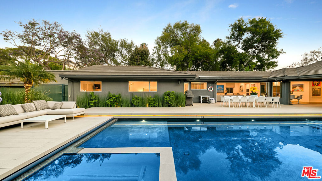 FULLY FURNISHED. PICKLEBALL COURT, BASKETBALL, PILATES REFORMER, GYM. 2 CAR GARAGE PLUS 5 CAR DRIVEWAY PARKING, EV CHARGER. POOL HAS A RETRACTABLE COVER. GATED. PRIVATE. The pinnacle of California living in this stunning single-story contemporary estate nestled in the prestigious Beverly Hills Flats. Designed with an emphasis on seamless indoor-outdoor flow, this fully remodeled residence features an open-concept floor plan flooded with natural light and curated with designer finishes throughout. The expansive living spaces boast wide plank wood floors, floor-to-ceiling sliders, and iconic pop art, creating a perfect harmony of sophistication and style. The gourmet kitchen opens to multiple entertaining areas, ideal for both intimate gatherings and large-scale entertaining.Step outside to your private oasis a resort-style backyard complete with a sparkling pool, spa, lounge areas, built-in BBQ, and al fresco dining under the stars. Surrounded by lush landscaping and tall privacy hedges, this home offers tranquility just moments from world-class dining, shopping, and entertainment. This turnkey estate is the ultimate expression of modern luxury and relaxed elegance in one of L.A.'s most coveted neighborhoods.