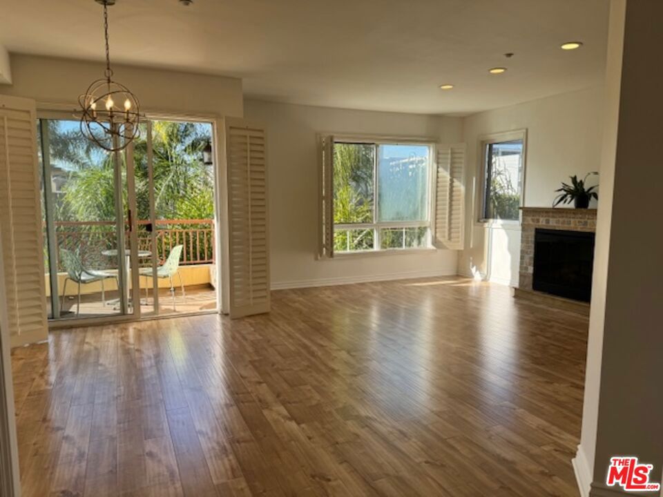 Beautiful bright 2 bedroom, 2 bathroom, front-facing unit bursting with natural light in a prime location!  A very spacious living room with decorative fireplace and private balcony with sunset views! Enjoy cooking at the gourmet kitchen with stainless steel appliances and granite countertops. Primary bedroom suite features a large walk-in closet, double vanity sinks, and separate soaking tub.  Enjoy hardwood floors, in-unit washer and dryer, central air conditioning, plantation shutters and recessed lighting throughout the unit.  2 assigned SIDE BY SIDE parking spots in a secure covered garage (with additional guest parking).  Excellent location close to Beverly Hills, West Hollywood and the Grove.  Walking distance to Cedars-Sinai, Beverly Center, and lots of great restaurants, cafes and shopping.