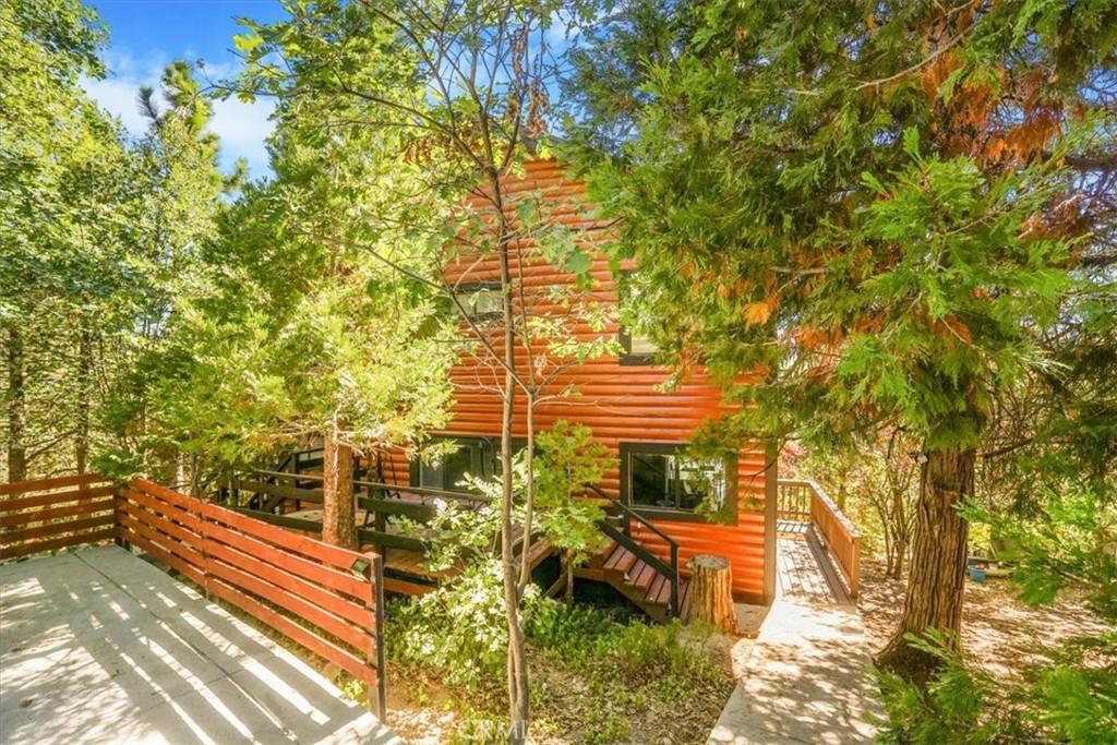 Escape to this stunning 3 bedroom, 2 bath, high ceiling view home nestled in the prestigious Lake Arrowhead community. Boasting a picturesque lake right, this charming retreat features high ceilings and a spacious living room complete with a cozy fireplace. The brand new kitchen and bathrooms offer modern luxury, while the upgraded flooring adds elegance to every corner. With parking for up to 4 cars on the private concrete pathway, there's plenty of room for guests to join in on the fun. Don't miss out on the opportunity to make this dreamy oasis your own!