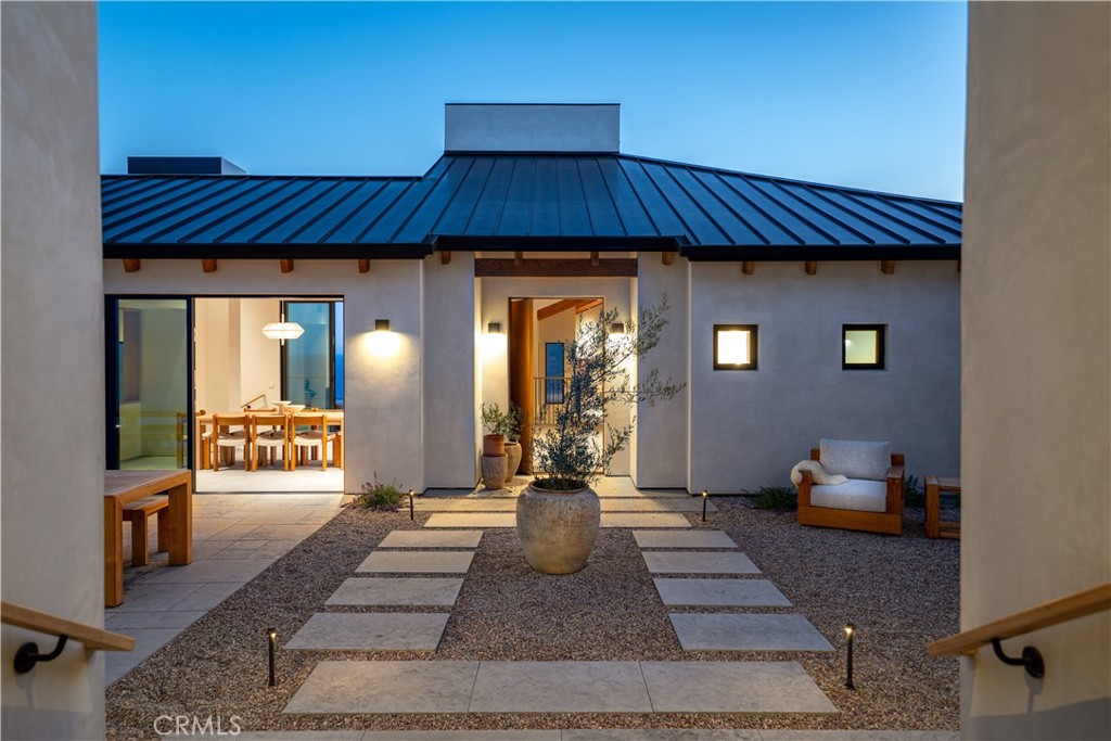 Welcome to Anacapa at Trancas Malibu — Where Coastal Beauty Becomes Deeply Personal
Perched above the Pacific in the heart of Trancas Malibu, Anacapa isn’t just a new home it’s a new way of being. The first of eight exclusive residences in this coveted enclave, Anacapa offers a rare blend of architecture and emotion, an experience where design meets soul, and nature shapes how you live. Set on a private knoll with commanding ocean views, this 7,200+ square foot estate features 5 bedrooms and 7 bathrooms, including a detached guest house, a private home theater, and gym. Every detail was intentionally chosen to create a life that is both elevated and grounded. From the moment you arrive, the world softens. Crafted with natural stone, rich wood finishes, and expansive glass, Anacapa harmonizes with the Malibu terrain, letting sea breezes, golden light, and mountain silhouettes pour into every room. Indoor and outdoor living flow seamlessly, with walls of glass that open to breathtaking terraces, a show stopping infinity-edge pool, and views that stretch from Point Dume to the Queen’s Necklace. Whether it’s a quiet morning watching the marine layer roll in or a golden-hour gathering with friends, every moment here feels expansive and intentional. And behind the beauty, this estate offers powerful, forward-thinking infrastructure, A full solar panel array with Tesla-style battery backup system, offering both sustainability and energy independence. A private water well and storage tank, ensuring long-term self-sufficiency. A custom fire suppression system that draws from the pool itself designed with both safety and resilience in mind. Set within a gated enclave just minutes from Trancas Country Market, Zuma Beach, and Malibu’s most iconic surf breaks of Zuma Beach & Broad Beach, Anacapa offers the serenity of a retreat with the lifestyle of the coast. This is more than a home. It’s a sanctuary. A statement. A feeling. This is Anacapa. And this… is Malibu, reimagined just for you.