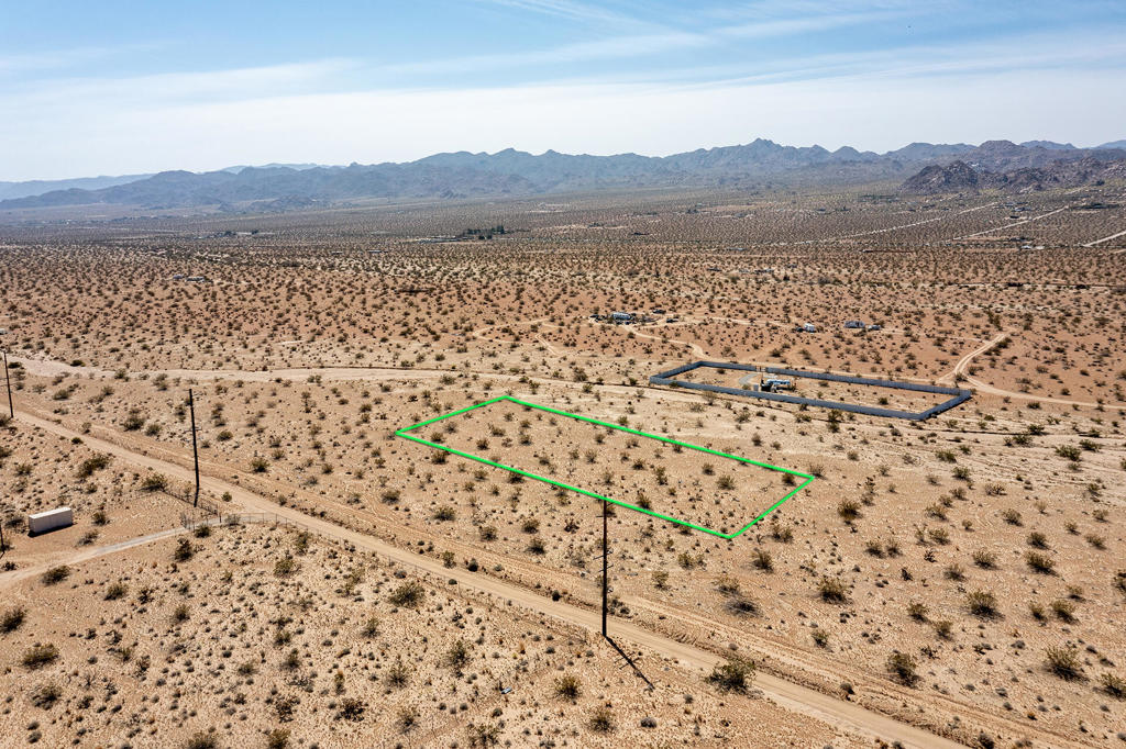 1.25 acres in world famous Joshua Tree. The Sunfair West neighborhood is known for its private quiet settings and beautiful vistas. Views of shadowy boulder studded hills on the Little San Bernardino Mtns. Snow capped peaks on Mt San Gorgonio. Bunker Mtn, Copper Mtn, and Mt Bartlett all offer an inspiring ambiance. Power is along Pipeline Rd only about 120ft away. Road may need to be graded to access the property from Pipeline. No water so go with a well. Zoned residential for a home and guest home. Horse property. Starry nights. Short drive to the JT Village for cafes, organic restaurants, bars and the JT Farmers market. Not far from Copper Mtn College. 9 miles to the Joshua Tree National Monument. In 2021 over 3 million tourists visited the park. About 5 miles to the JT Lake Bed for off-roading and wilderness exploring. Ideal for a designer home and compound. More celebrities, artists, and musicians are calling JT home than ever before. 37 miles to Palms Springs. 131 miles to LA. Buyers must contact the county for all questions on building and uses. Buyers must contact the solar, well and wi-fi companies for all questions on utilities. Address is not a real address and is for marketing purposes only. (APN) 0604-191-20-0000 Don't Wait! - Call Now! GPS: 34.145517 -116.270865