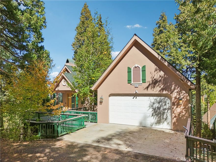 Truly gorgeous 3 level home featuring 5 bedrooms and 3.5 bathrooms with Lake Rights, is ready to be made yours! Enter through a custom glass door with bear/nature design into this spacious home on the top floor with beautiful wood panel cathedral ceilings offering recessed lights, stone flooring, a floor to ceiling stacked stone fireplace and a wall of windows showcasing beautiful forest views! The living room flows into the dining area and recently remodeled kitchen with wood cabinetry offering plenty of storage space, a kitchen island forest mural plus stainless steel appliances. Both the dining area and the living room have sliding glass doors that open to the huge Trex deck with built in BBQ located on the top floor - this is the perfect space for relaxing and entertaining guests! All of the bedrooms are located downstairs on the 2nd floor including the massive primary suite with a fireplace a large walk-in closet, and a spa-like ensuite with soaking tub, separate shower, and dual sinks. There is also a hall bathroom for the 4 secondary bedrooms to share, a large laundry room, and a covered Trex deck with included Spa! Down on the 1st floor you will be able to enjoy a large game room/family which also features a fireplace and a 3rd Trex deck to enjoy! This home also features dual generators, dual HVAC systems, and attached 2-Car, extra deep, Garage and driveway parking for 2! The home is also ADA accessible! Also located not far from the lake and many outdoor activities to enjoy! The access road is serviced by the County. Schedule an appointment and come tour today!