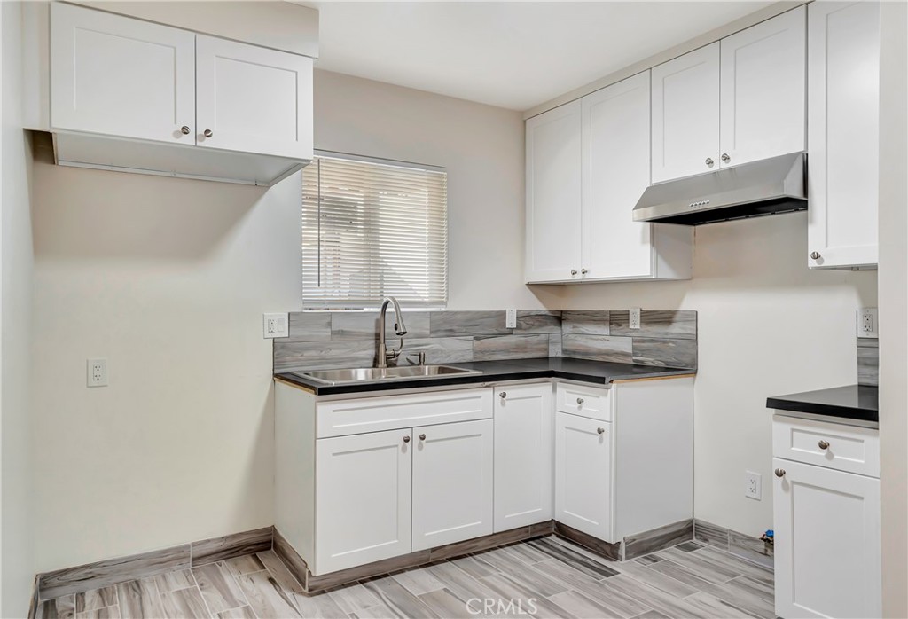This beautifully updated 2-bedroom, 2-bathroom apartment at 14233 1/2 Sylvan Street offers a bright, modern living space featuring a sleek kitchen with granite countertops, custom white cabinetry, and a stainless steel range hood. Both bathrooms are finished with contemporary tile, frameless glass shower doors, and stone countertops, while the bedrooms showcase hardwood floors, large windows, and ample closet space. With stylish tile flooring in the main areas, updated lighting, and a smart layout, this well-maintained fourplex unit provides comfort and convenience in a prime Van Nuys location close to shopping, dining, and transit.