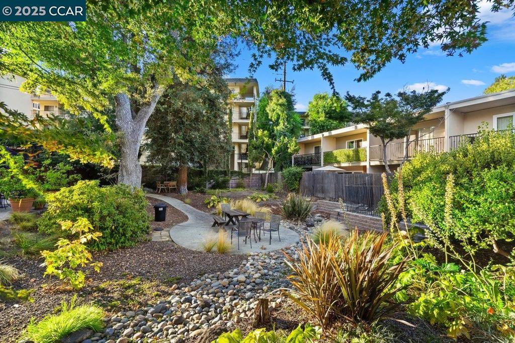 Beautifully updated 2 bedrooms 1.5 baths town-house style condo in one of the most desirable and convenient locations in Walnut Creek! Features include an updated kitchen with quartz countertops, dining area opening to private patio, and spacious living room with brand new sliding doors that lead to a serene backyard oasis and community pool. Upstairs offers 2 large bedrooms, including a primary bedroom with private balcony. Upgrades include laminated floors, new double-pane windows, doors, light fixtures and all sliding glass doors. Assigned carport in front. Community amenities include swimming pool, garden and barbecue area. HOA covers hot water, hazard insurance, exterior maintenance and trash removal. Close to Iron Horse trail, downtown, BART, Kaiser, schools and I680/24 freeway access.