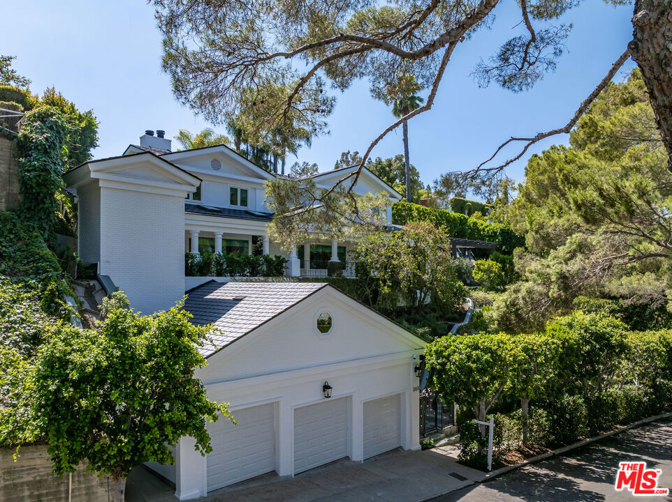 Completely Reimagined Prime Little Holmby Traditional home is set on one of the neighborhood's most desirable streets. It boasts captivating curb appeal with lush landscaping by renowned landscape architect Mark Tessier, including olive trees, star jasmine vines, and ficus hedges for ultimate privacy. The expansive backyard is a true highlight, featuring a large swimmer's pool, custom outdoor trellis with four patio heaters and drapery for shade, an outdoor BBQ, and a patio area surrounded by lush trees creating a peaceful vibe. Inside, the home is bright and welcoming, showcasing fine architectural character. The spacious formal living and dining rooms are perfect for hosting, while the brand-new chef's kitchen with top-of-the-line Miele appliances is unlike anything currently available on the market. All of this flows seamlessly into the stunning backyard, pool, patio, and custom trellis, ideal for entertaining. Boasting five bedrooms, the Primary Suite includes a large closet and a state-of-the-art, newly remodeled bathroom. Notable upgrades include a new HVAC system, Lutron lighting control systems, indoor/outdoor Sonance speakers with Sonos, custom LED lighting, a commercial-grade elevator that connects the garage drop-off zone directly to the home's entry, a three-car garage with polished epoxy flooring, built-in storage, and a bonus loft for additional storage, lime wash paint in the living and dining rooms, custom drapery in every room, brass finishes throughout the home, engineered white oak flooring, a new roof, and two legal addresses/APN's. All of this is just moments away from Westwood Village, The Geffen Playhouse, and Warner Avenue Elementary, this home blends classic elegance with modern functionality, perfectly suited for indoor-outdoor California living.